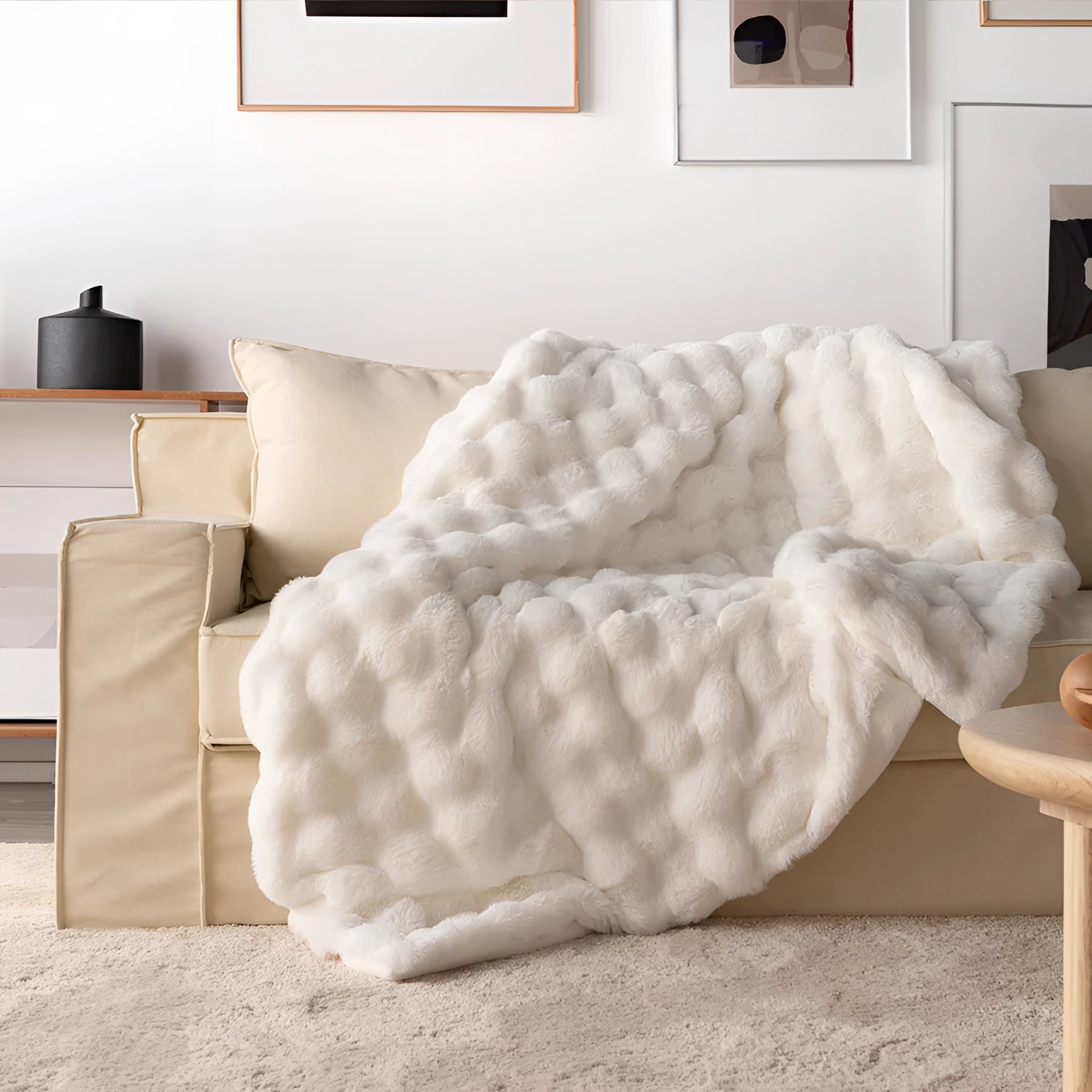 Luxury handmade chunky knit weighted blanket in ivory cream, elegantly draped over a beige couch in a cozy living room setting, measuring 160x200cm.