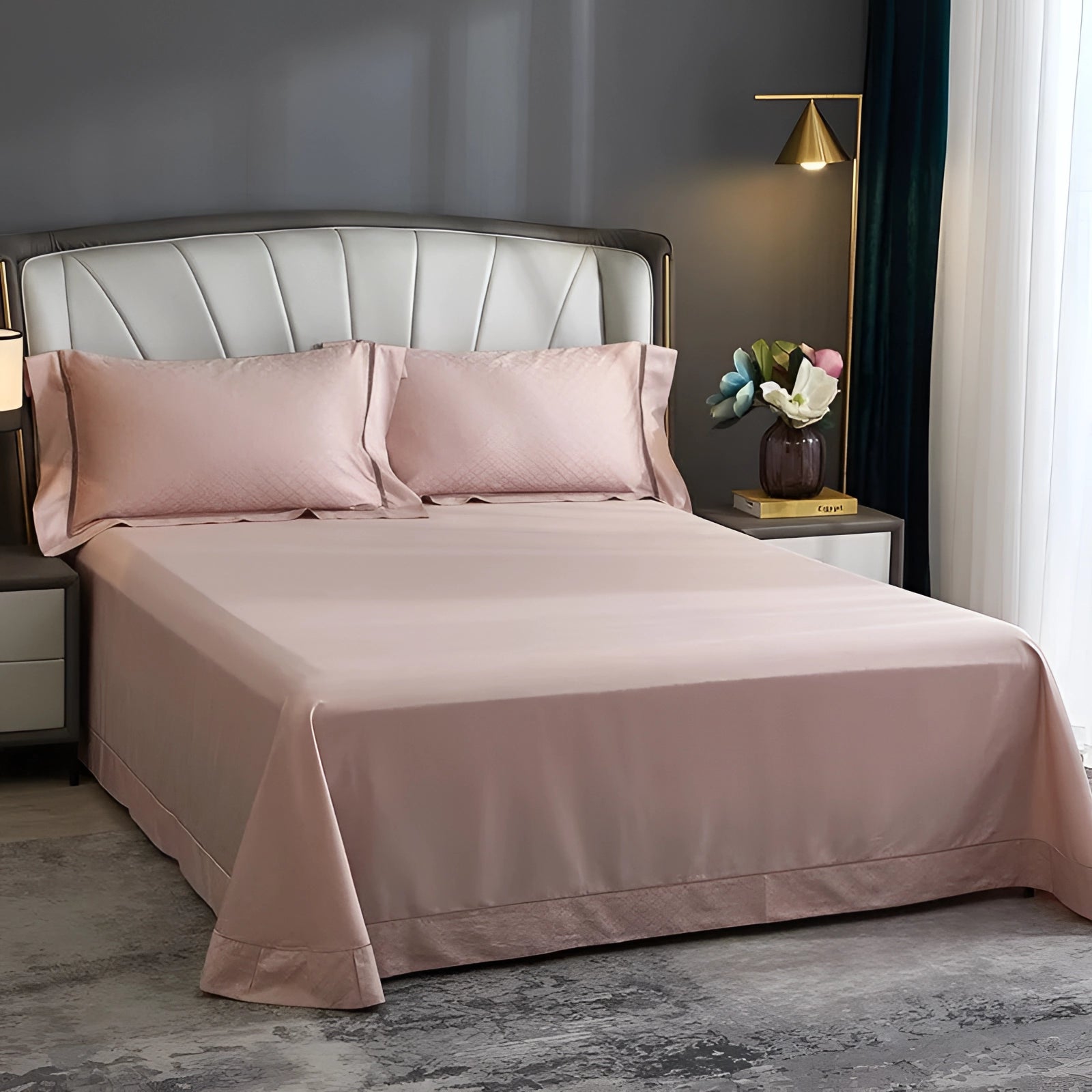 Luxury pink satin bedding set with a geometric pattern, featuring a duvet and matching pillowcases, elegantly displayed in a cozy bedroom setting with wooden furnishings and soft curtains.