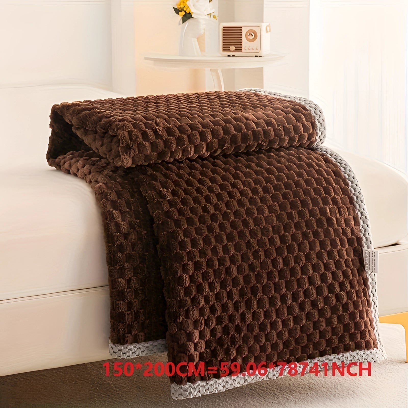 Luxurious dark coffee colored textured blanket with pom-pom trim draped on a wooden floor, showcasing its plush and cozy woven woolen design in a large rectangle size of 200 x 230cm.