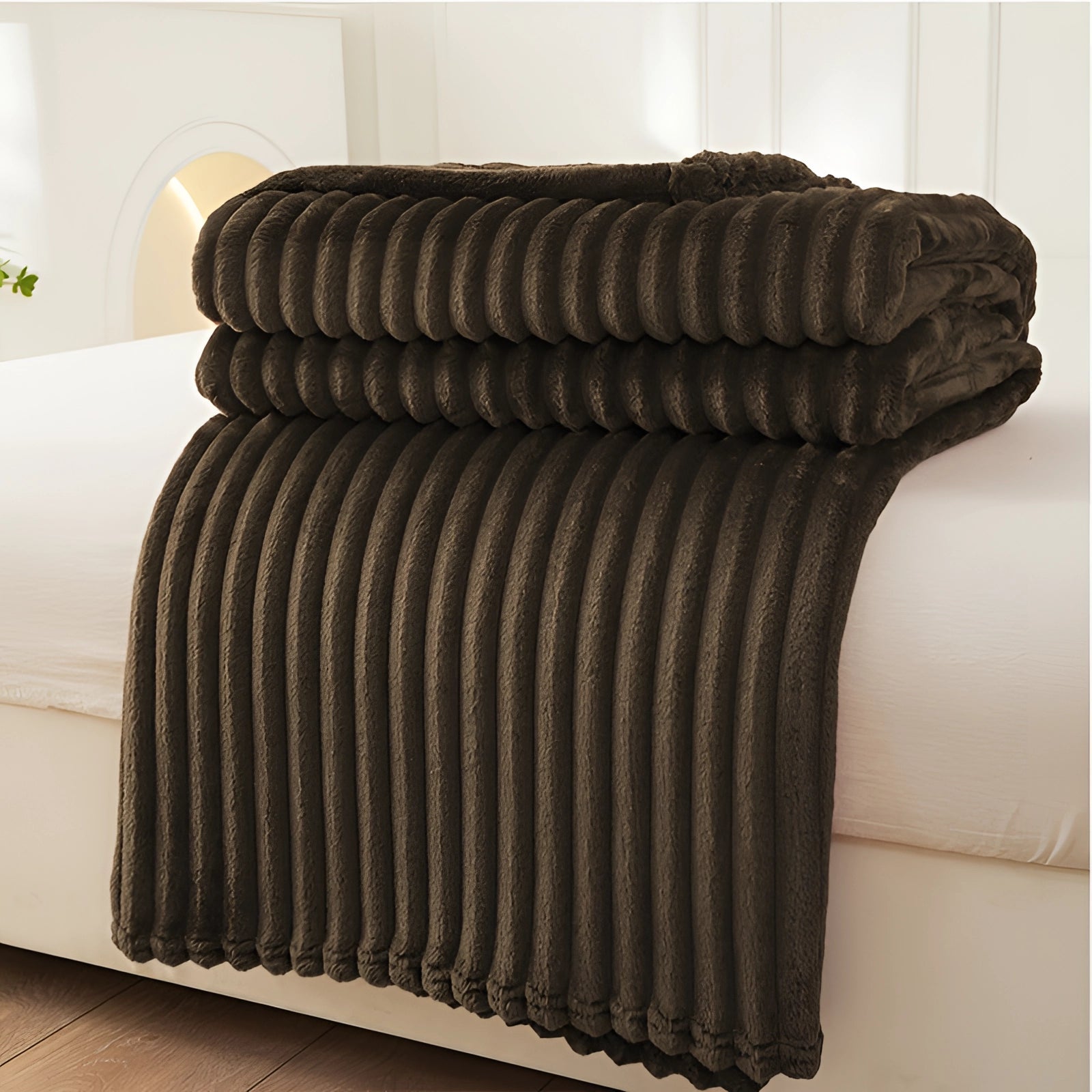 Luxurious royal blue velvet ribbed throw blanket in dark brown color, measuring 200 x 230 cm, shown folded neatly on a wooden surface.