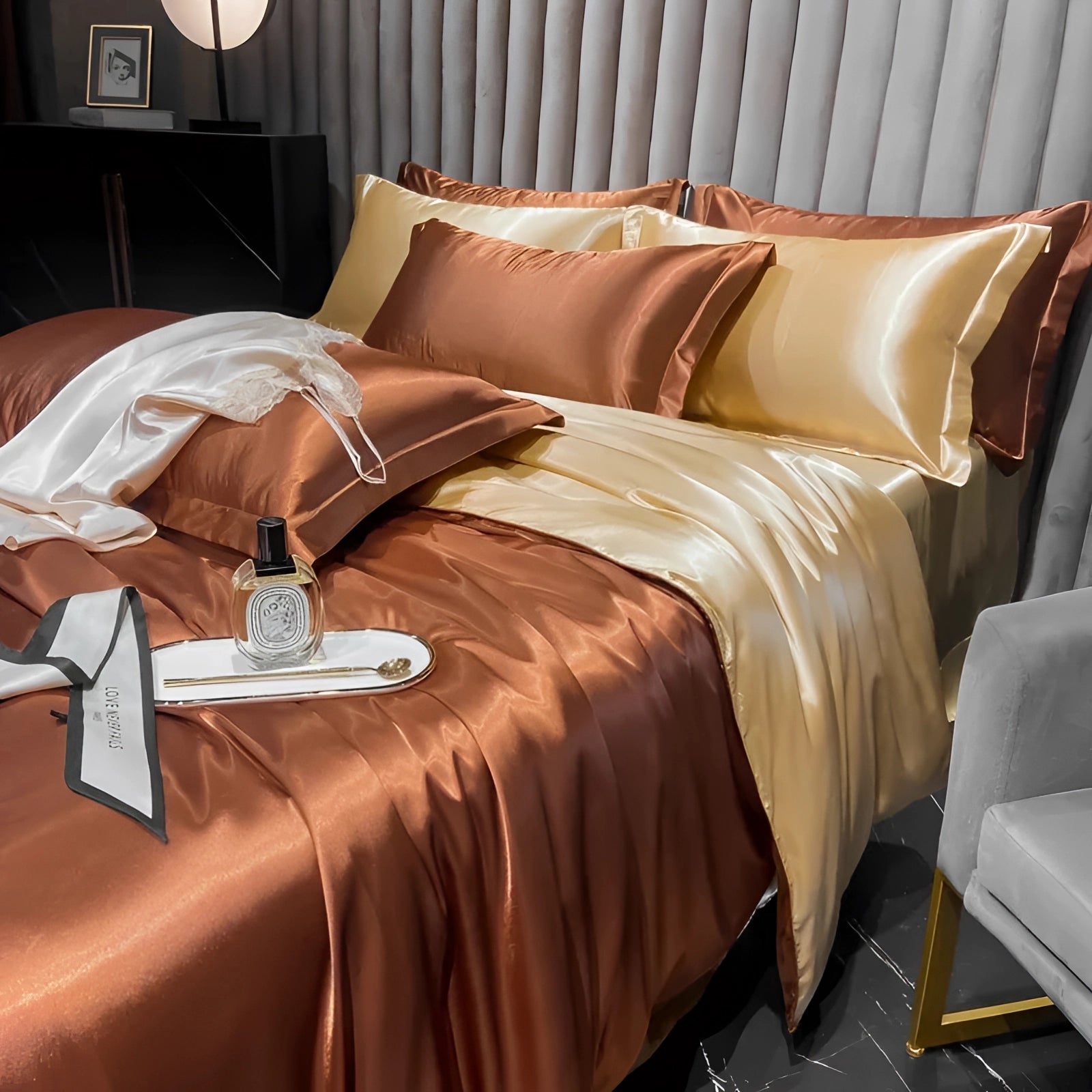 Luxurious brown silk bedding set featuring copper satin sheets and elegant pillowcases on a bed with a wooden frame, set in a cozy and well-lit interior.