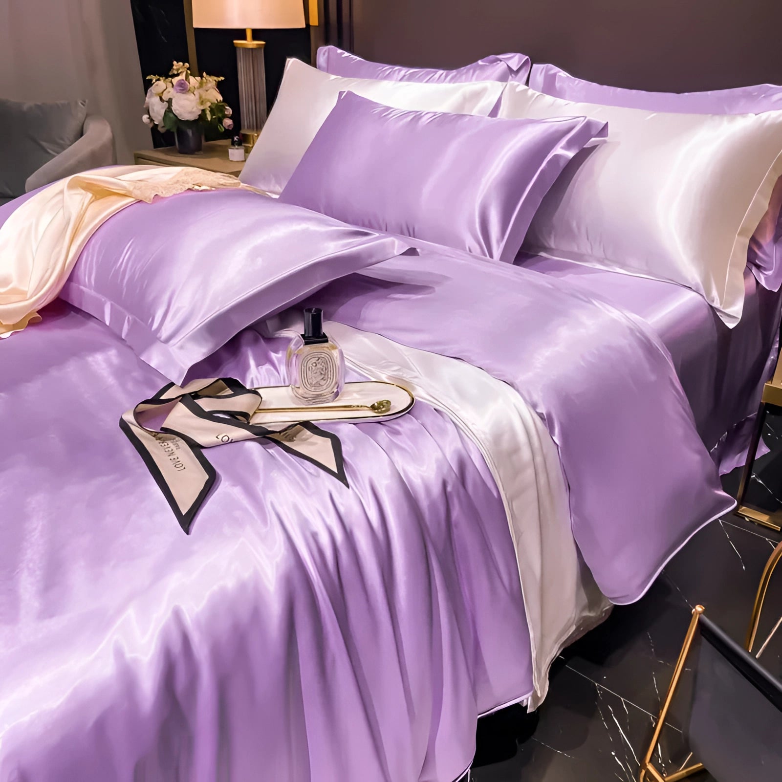 Luxury violet silk bedding set featuring copper satin sheets and elegant pillowcases, displayed with a plush bed skirt on a neatly arranged bed in a stylish interior setting.