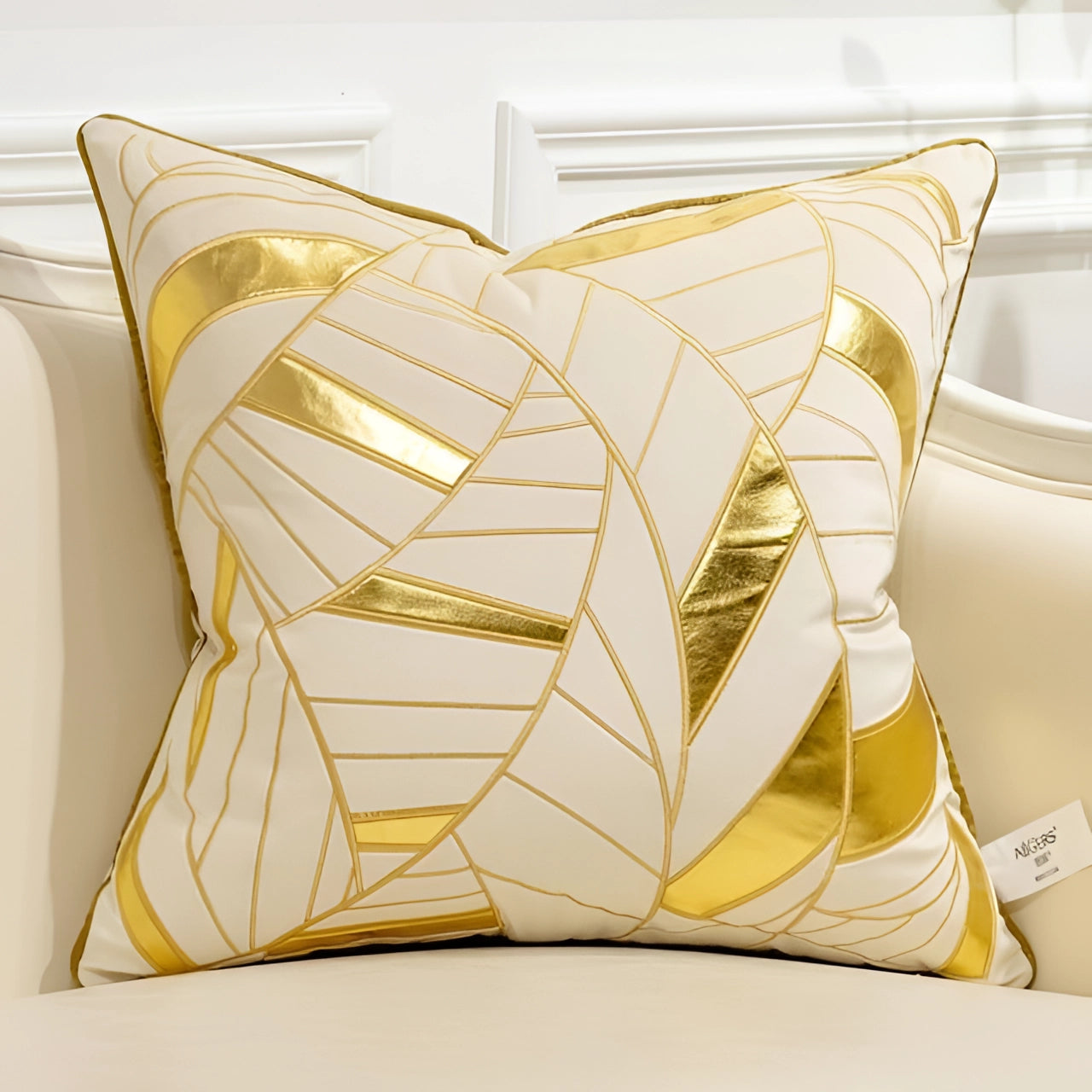 Luxury velvet throw pillow in cream and gold with an abstract geometric design featuring triangles and rectangles, measuring 18" x 18".