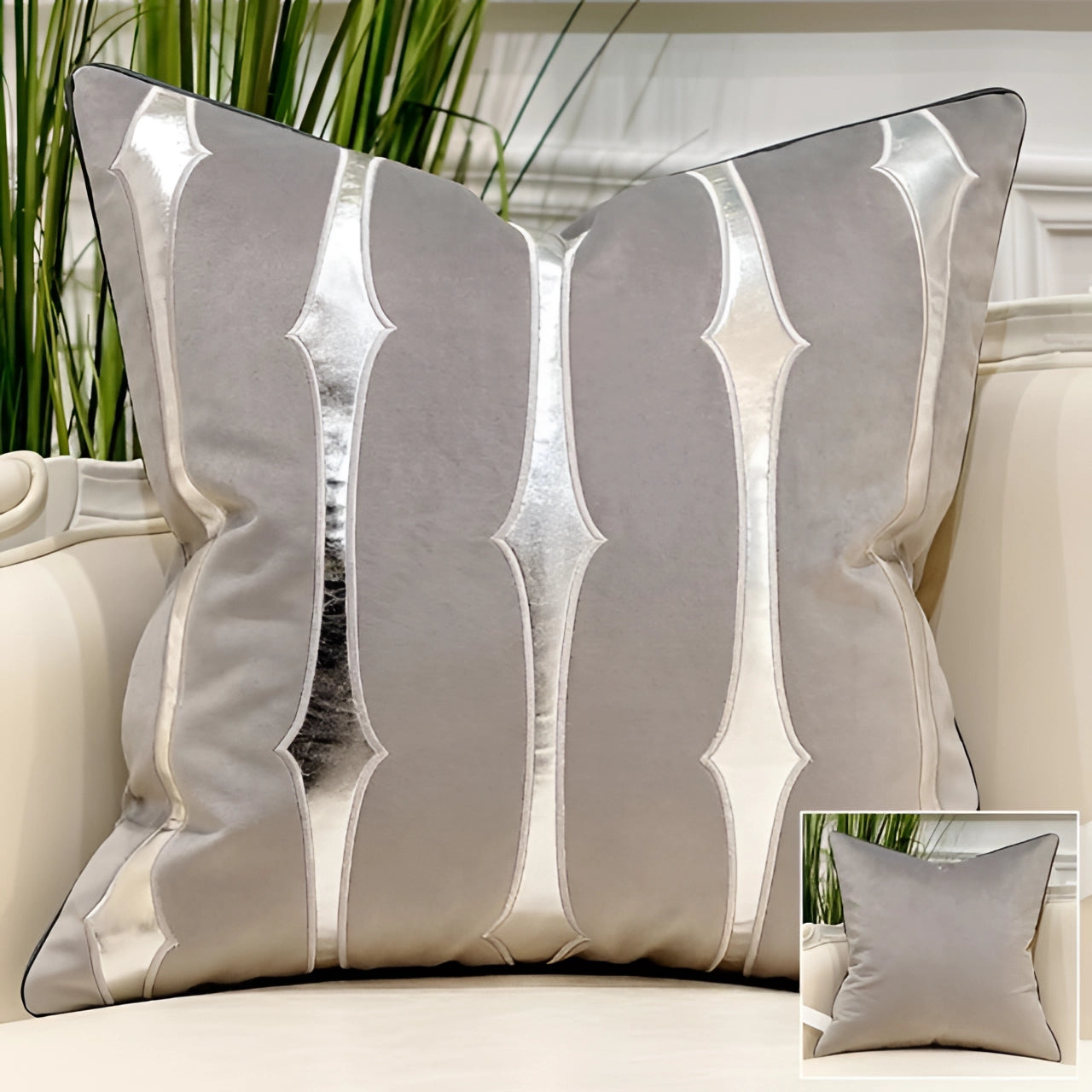 Luxurious gray-silver velvet throw pillow with gold accent geometric stripes, placed on a wooden chair in a stylishly designed interior setting, with a touch of greenery from a nearby plant.