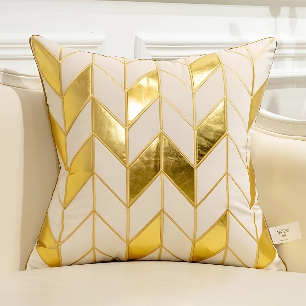 Cream and gold luxury velvet throw pillow featuring a geometric puzzle pattern with symmetrical triangles and rectangles, measuring 18" x 18".