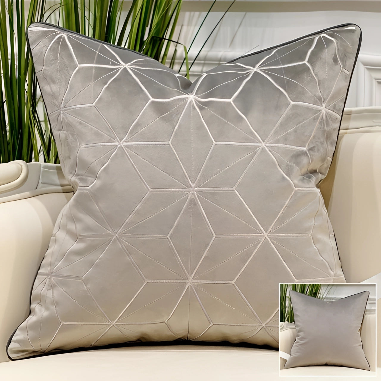 Luxury gray-silver velvet throw pillow with gold accent geometric pattern, styled in a constellation design, placed on a textured surface with a plant nearby, enhancing modern interior decor.