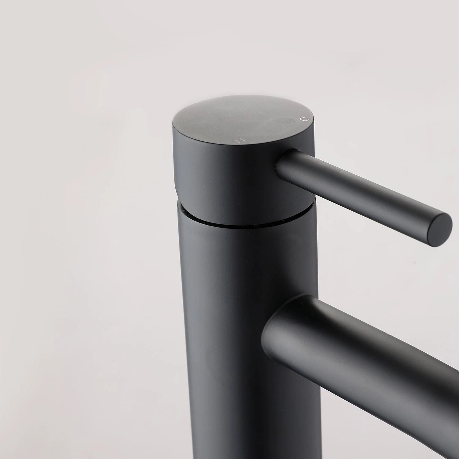 Matte black modern bathroom faucet with a sleek minimalist design featuring a cylindrical shape made from metal materials, including titanium and steel.