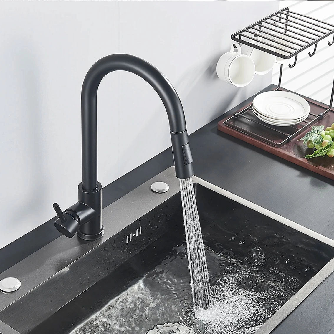 Matte black pull-down kitchen faucet with a sleek design featuring a 360° swivel spout, installed over a kitchen sink.