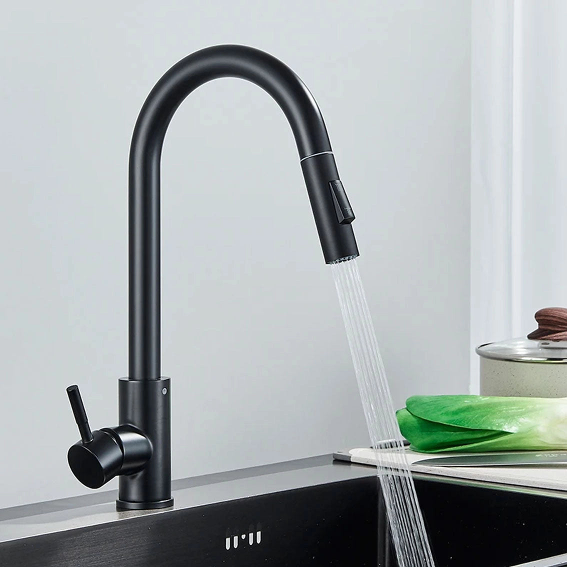 Matte black pull-down kitchen faucet with a sleek handle and a 360° swivel spout, featured against a neutral background.