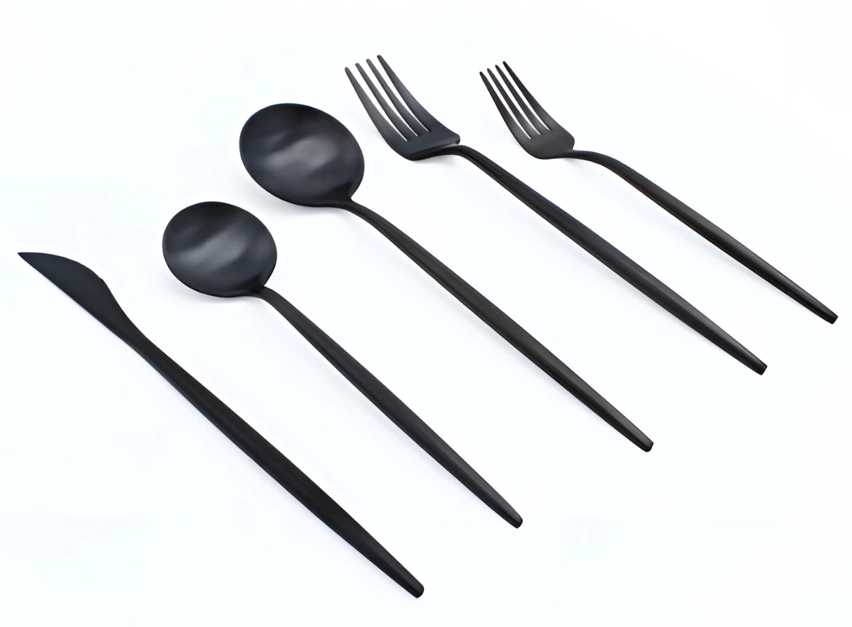 Matte black stainless steel cutlery set arranged elegantly on a table, showcasing luxury designer flatware with a modern and sleek appearance.