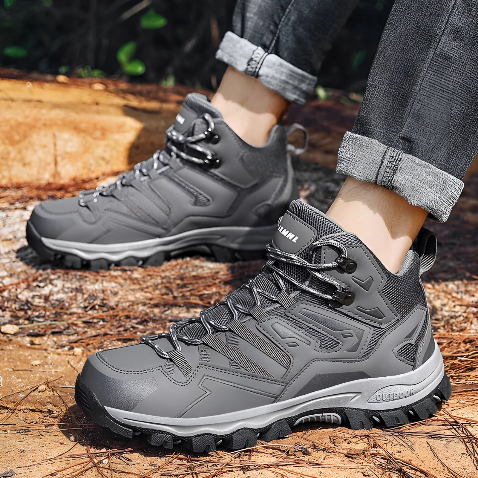 Men's waterproof lightweight hiking boots with a high-traction sole, shown outdoors on grass. The boots are predominantly black with white accents, designed for multi-terrain use.