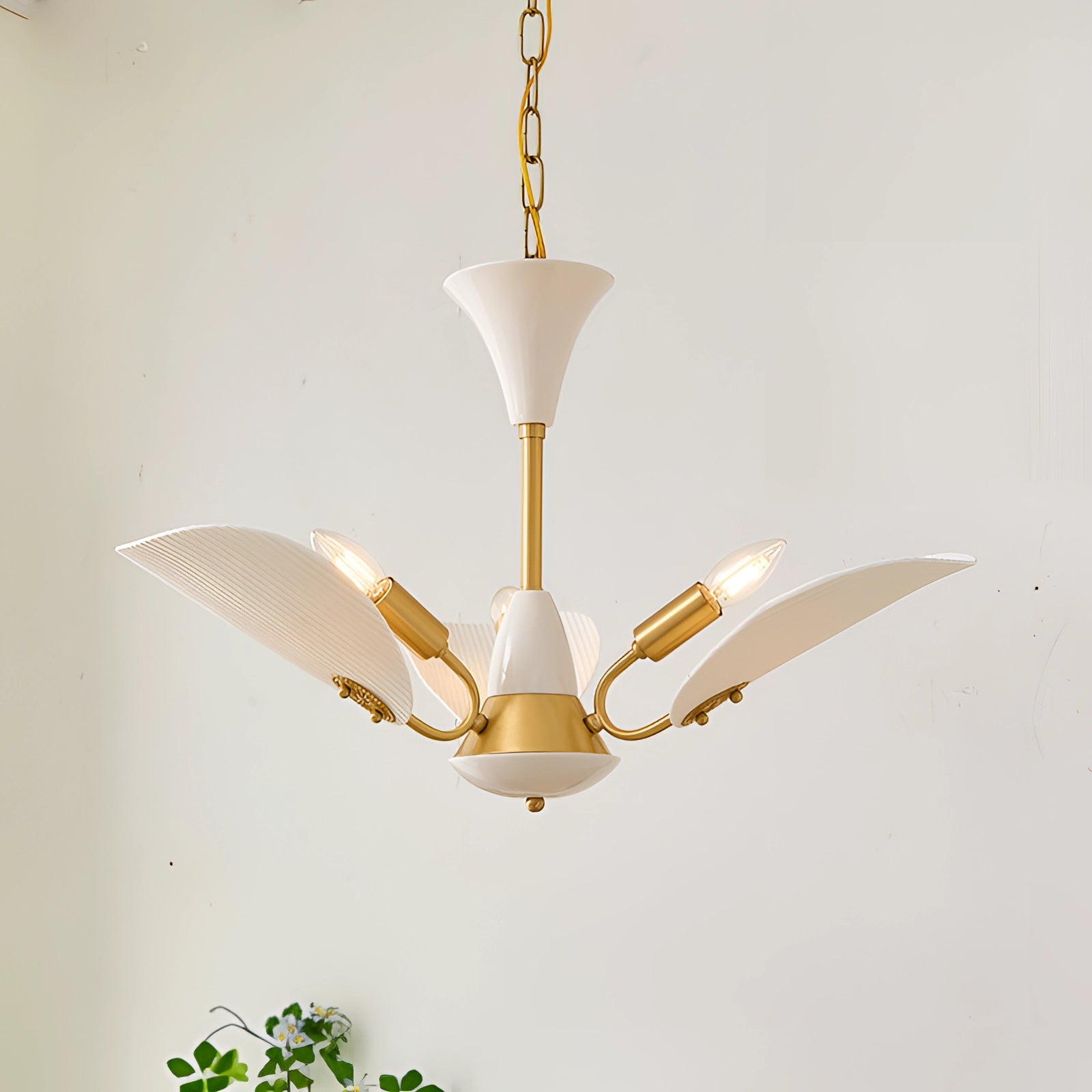 Mid-century modern brass chandelier with white glass pendants, featuring a 3-light design, showcasing symmetrical circular shapes and metal construction.