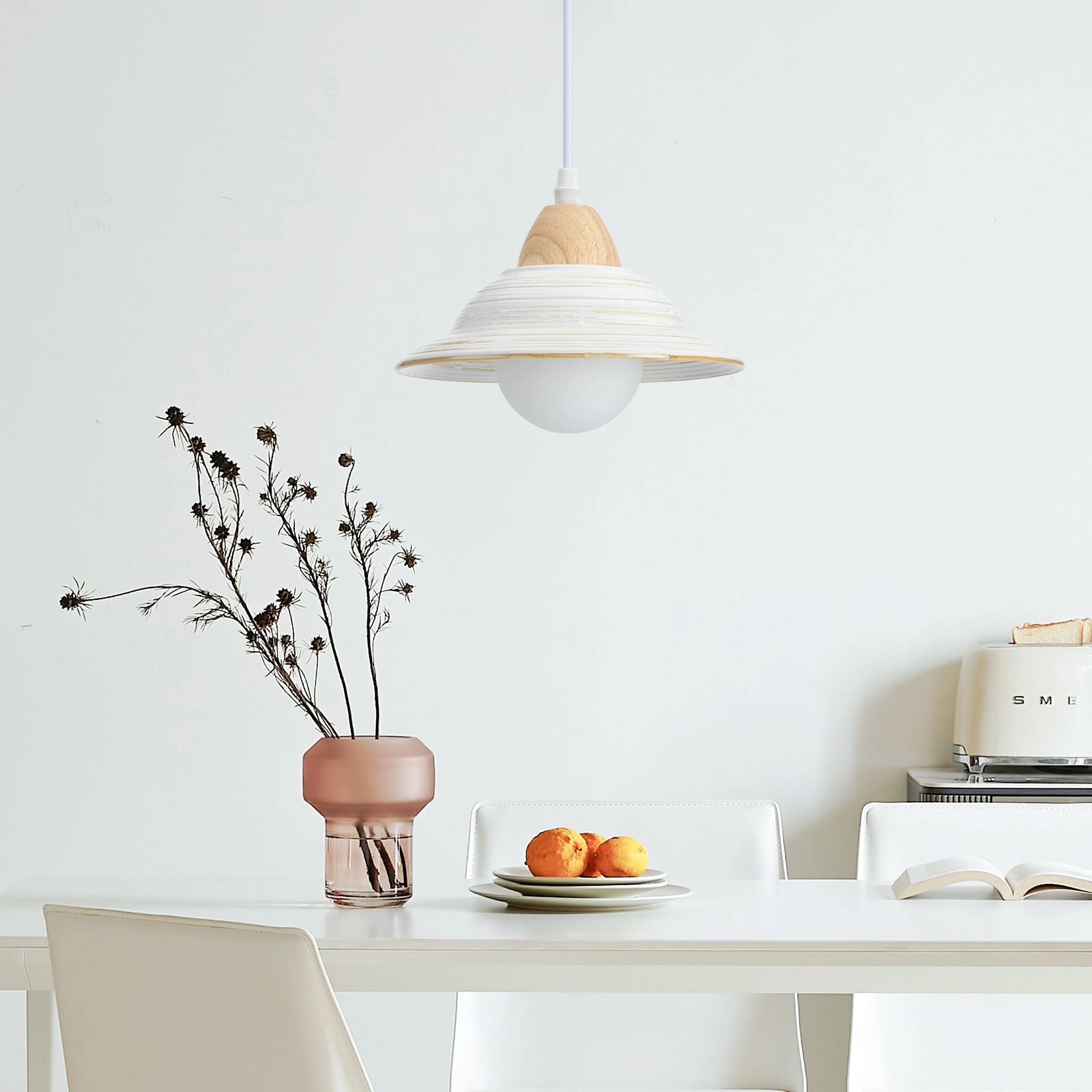 Minimalist Scandinavian Wooden Pendant Light hanging above a Nordic dining table set with tableware, surrounded by grey interior design elements, wooden shelving, and potted plants.