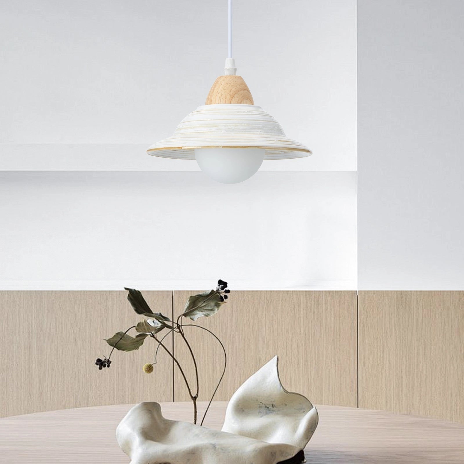 Minimalist Scandinavian wooden pendant light with a white shade, hanging above a Nordic dining table, featuring beige and wood elements, integrated into a stylish interior design.