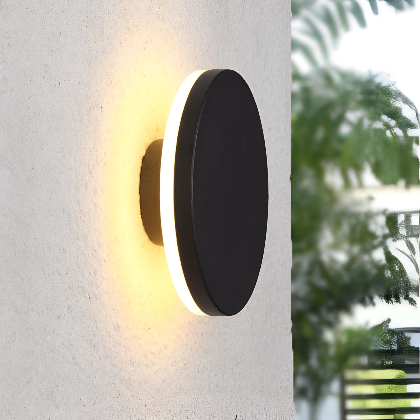 Modern black circular LED wall sconce with a minimalist halo glow, featuring a sleek round design in a large size, set against a neutral background.