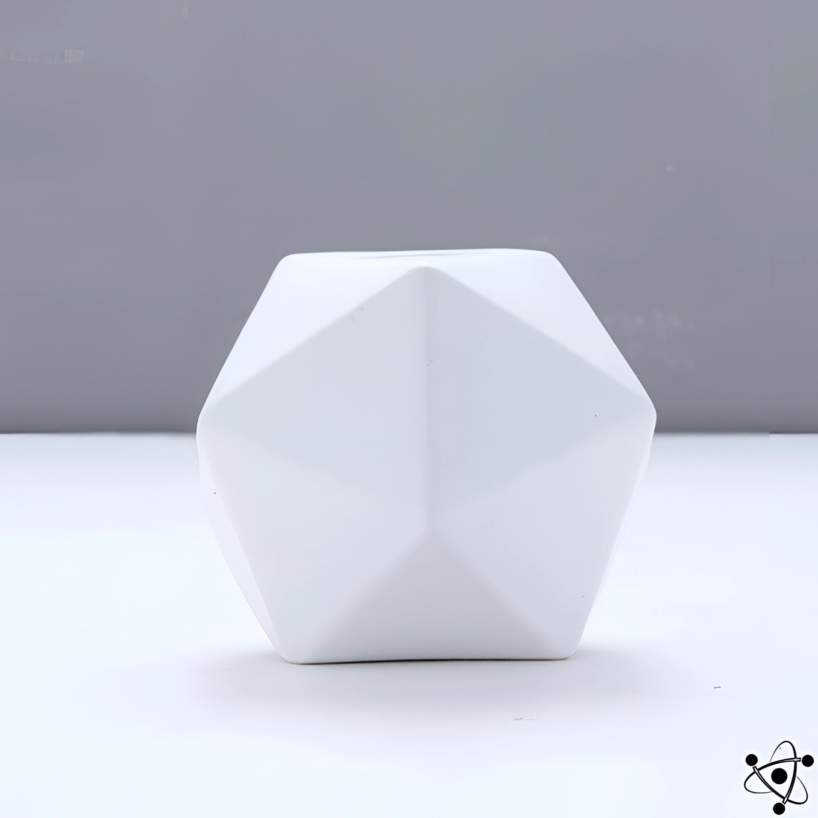 Modern white geometric faceted vase with a unique contemporary design featuring triangular and circular patterns, made from a natural and transparent material, ideal for creative and artistic home decor settings.