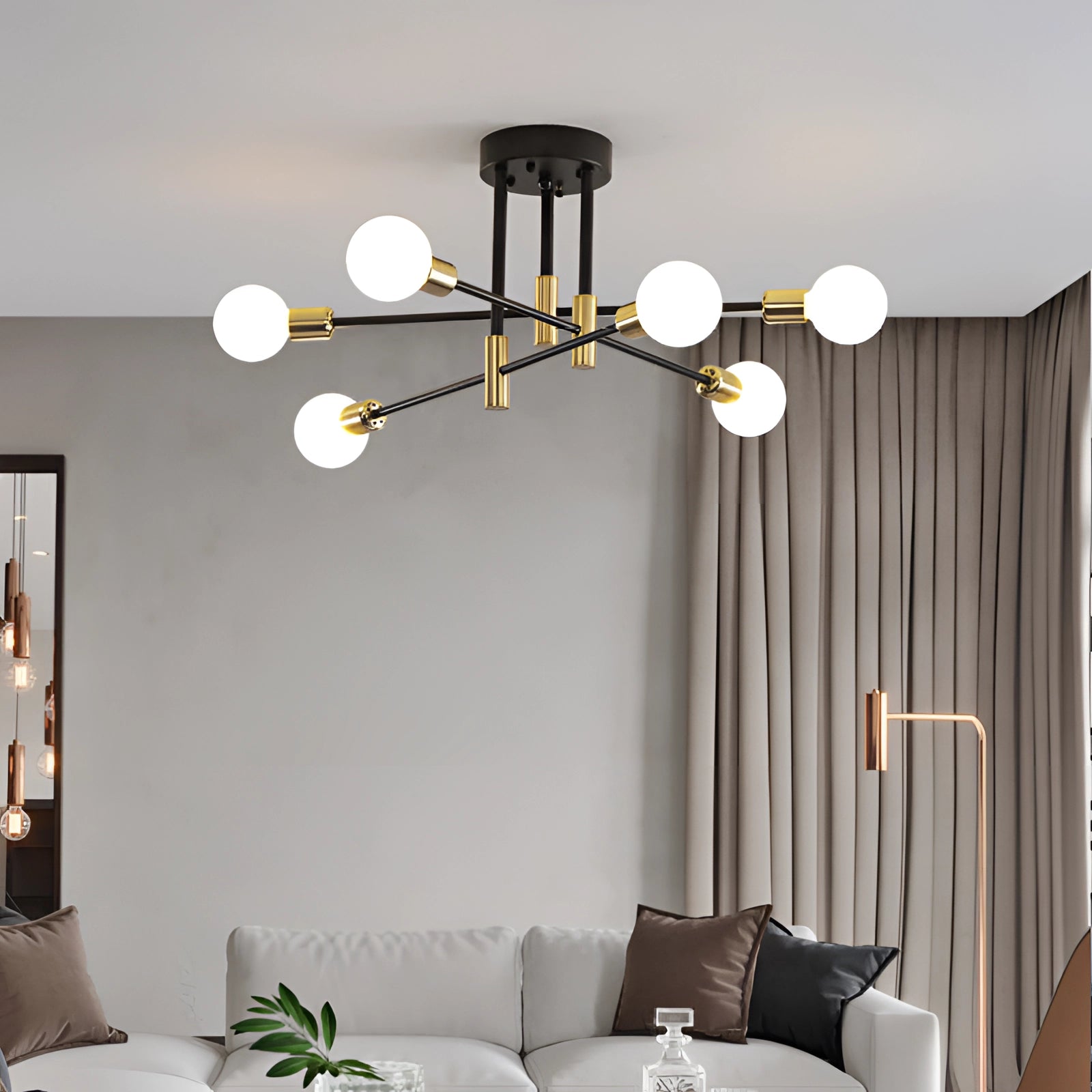 Modern black and gold mid-century adjustable glass chandelier with six milky white bulbs emitting warm light, hanging in a stylishly decorated living room featuring a couch, wooden table, and comfortable interior design elements.