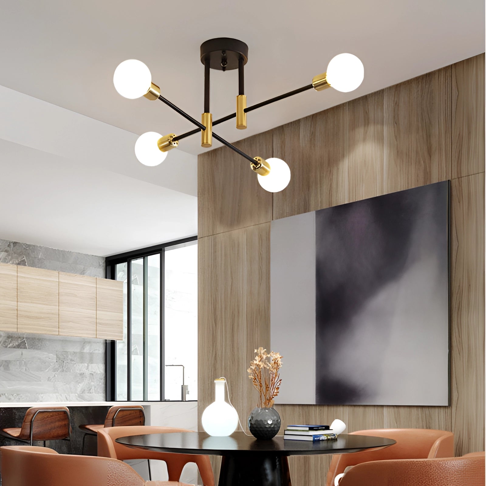 Modern black and gold mid-century adjustable glass chandelier with four milky white warm light bulbs hanging in a stylish, well-furnished living room featuring a table, couch, and wooden elements.