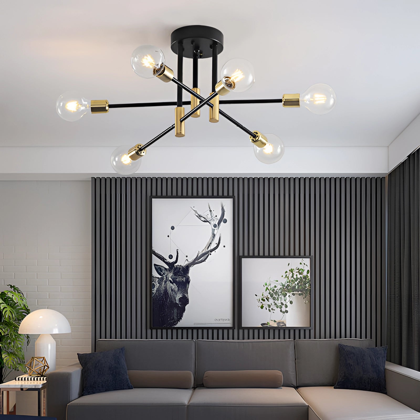 Modern black and gold mid-century adjustable glass chandelier with six warm light clear bulbs, hanging in a stylish interior with green plants, wooden furniture, and a couch.