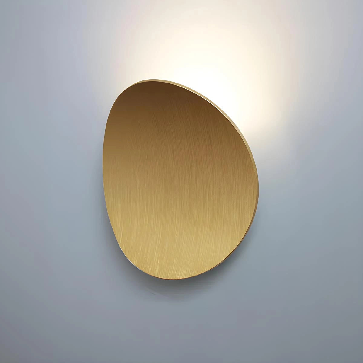 Modern black LED wall light with a gold finish, featuring a contemporary minimalist sconce design, mounted on a wooden background with circular and cylindrical metal elements.