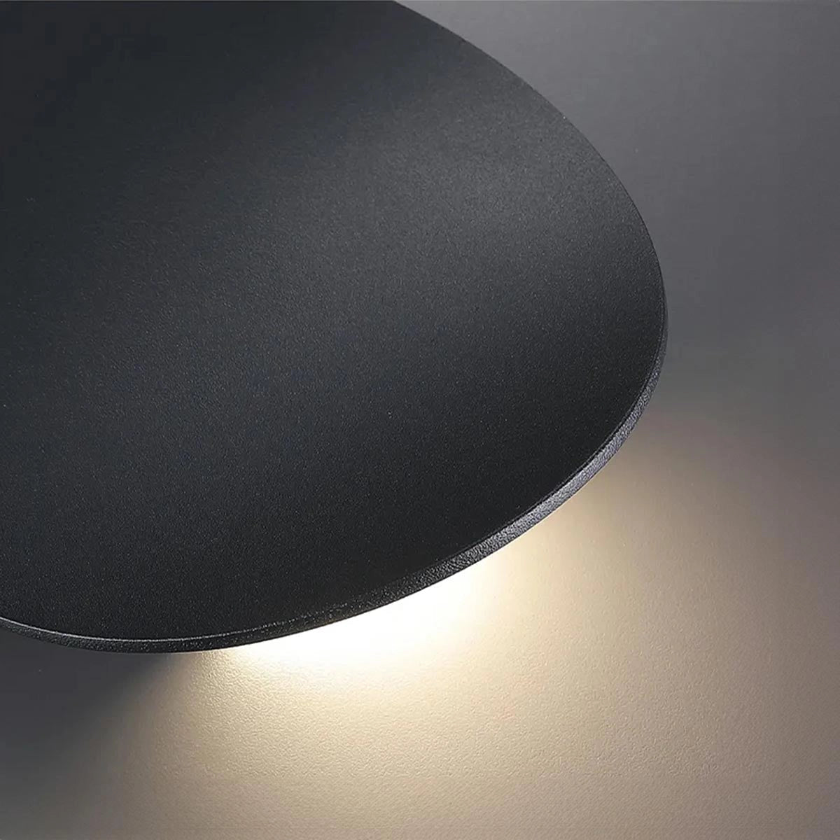 Modern black LED wall light with a contemporary minimalist design, featuring a sleek circular shape and metallic finish.