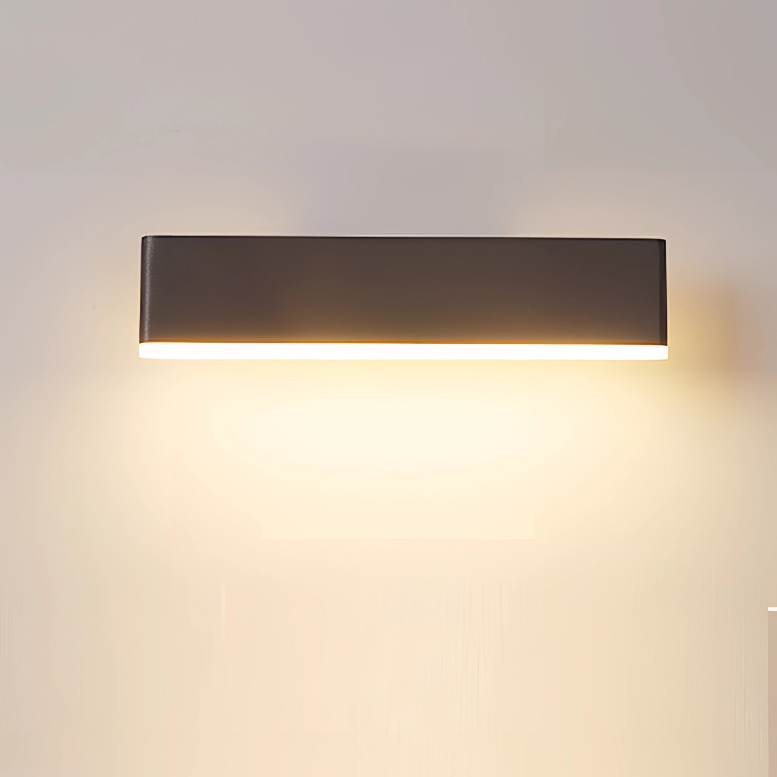 Modern black LED wall sconce with a minimalist geometric design, featuring a rectangular shape and metal finish, mounted on a wall in a room with wooden elements and a ceiling fixture.