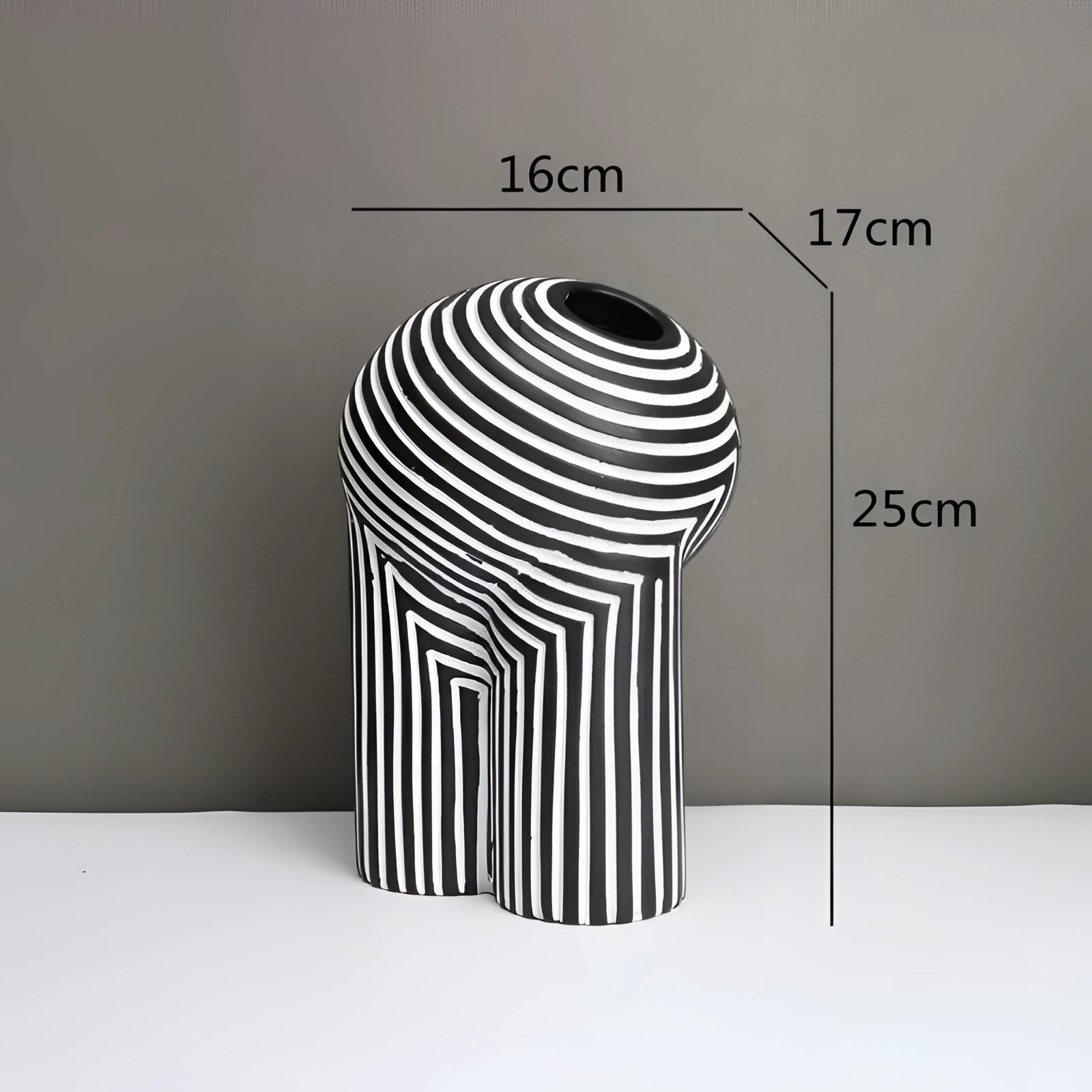 Modern black and white striped ceramic vase with an optical illusion design, measuring 25cm in height and 16cm in width.