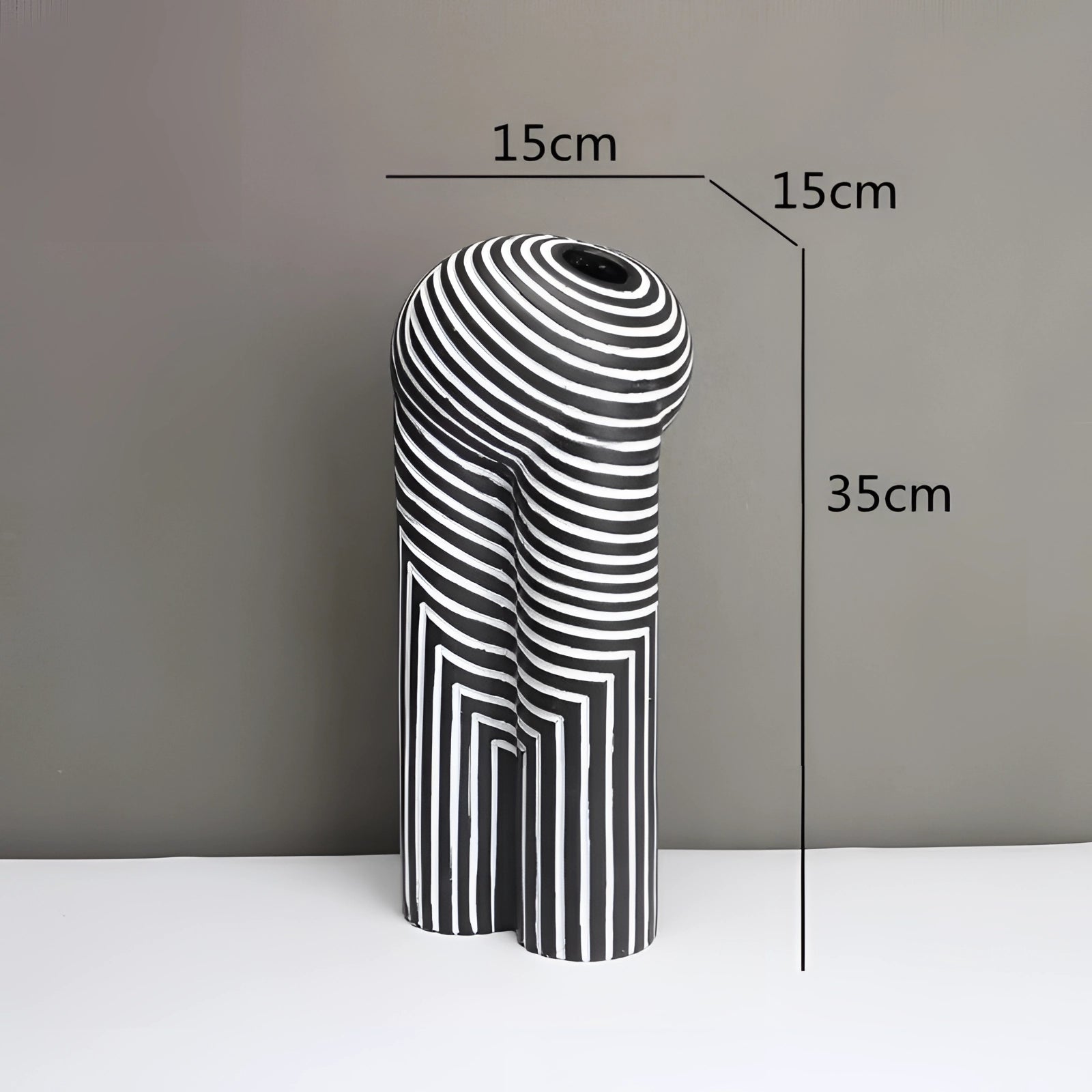 Modern black and white striped ceramic vase with an optical illusion design, featuring a cylindrical shape and artistic pattern. The vase is large, measuring 35x15cm, creating a striking visual impact with its monochrome graphic elements.