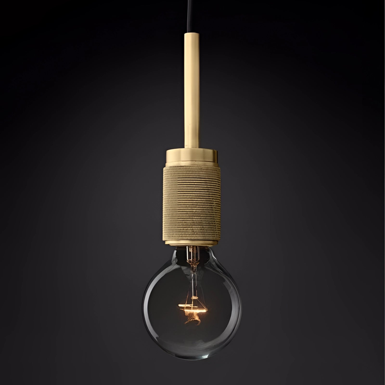 Modern brass finish pendant light with an adjustable industrial design, featuring a simple yet elegant look and a visible light bulb.