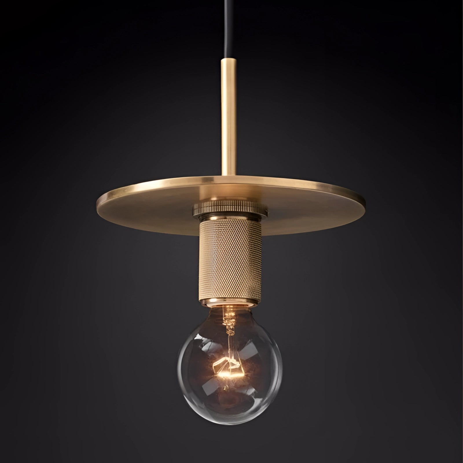 Modern brass finish pendant light with flat armed design and an adjustable feature, hanging from the ceiling, showcasing an industrial style with a light bulb and ceiling fixture.