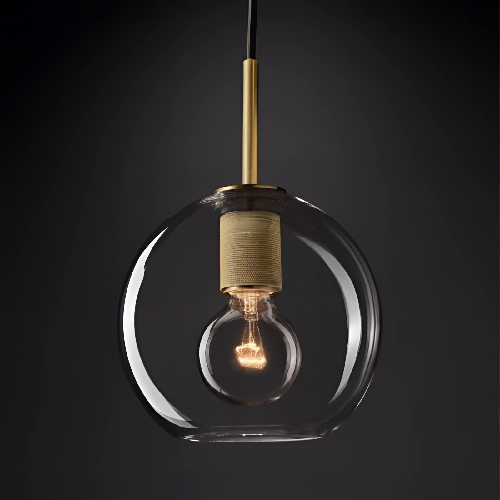 Modern Brass Finish Globe Pendant Light - Adjustable Industrial Lamp hanging from the ceiling, featuring a spherical design with visible light bulb and brass finish.