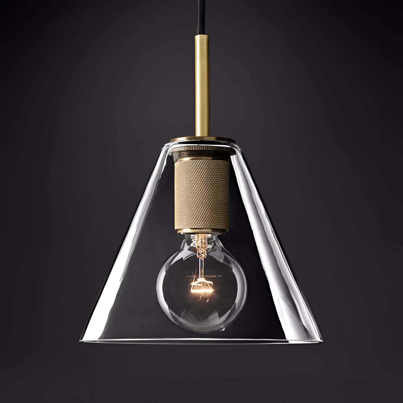 Modern brass finish pendant light in a classic design, featuring an adjustable industrial-style lamp with a conical metal shade, providing a warm glow in a dark room.