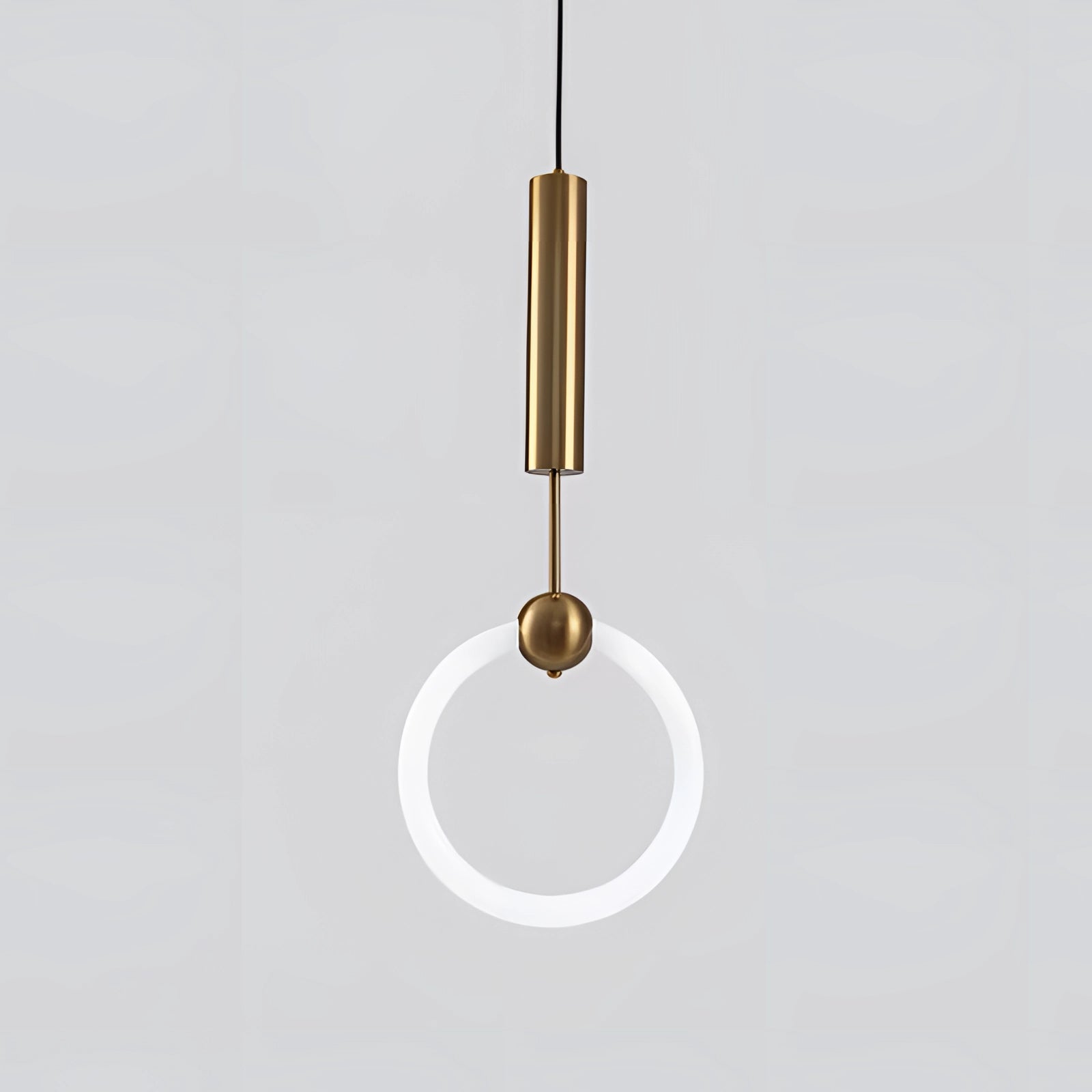 Modern brass geometric pendant light with a circular design, hanging from the ceiling as a luxury designer fixture, showcasing intricate metalwork and symmetry, enhancing interior design with its elegant presence.