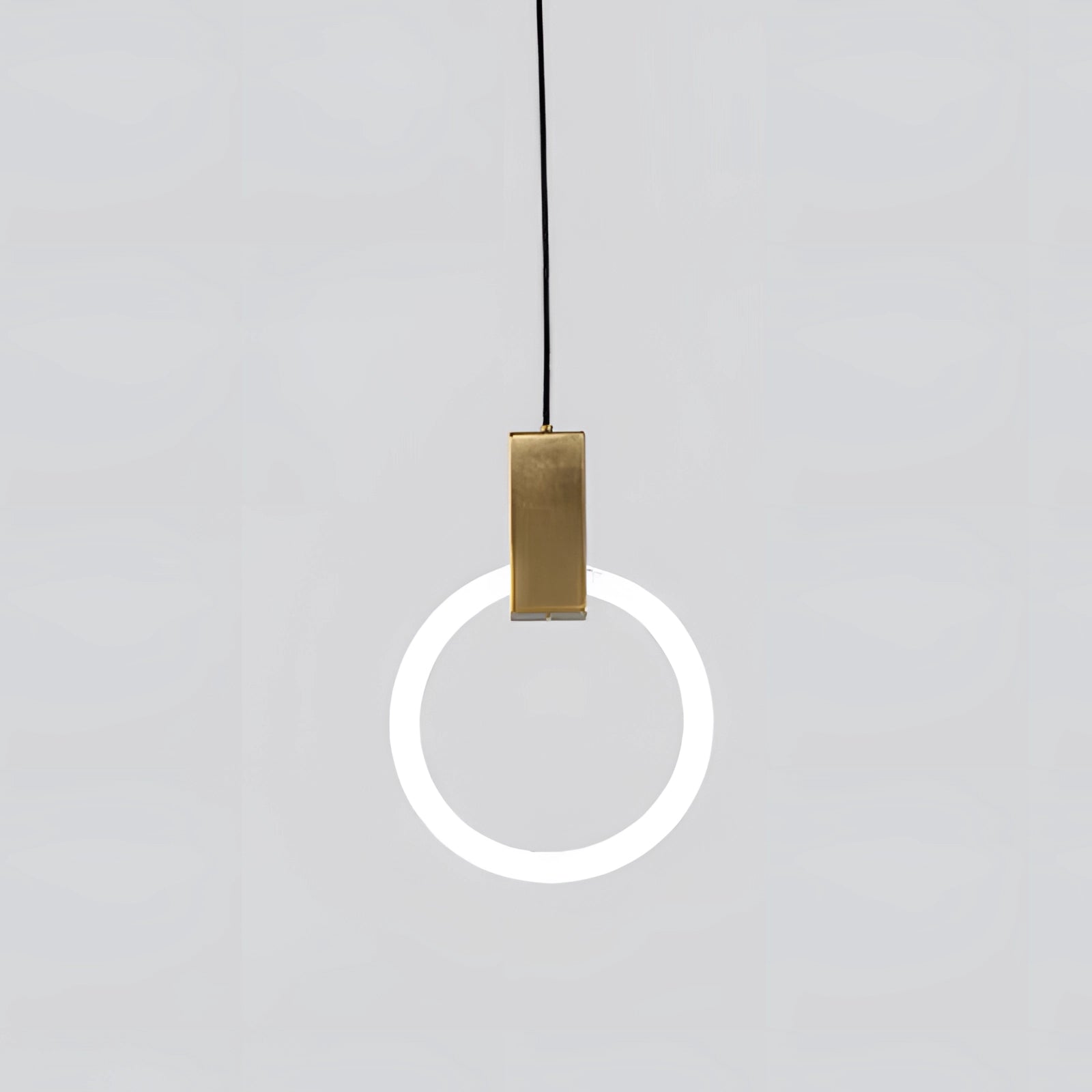 Modern brass geometric pendant light fixture with a large rectangular design, featuring sleek metal elements and contemporary styling suitable for upscale interiors, suspended from the ceiling.