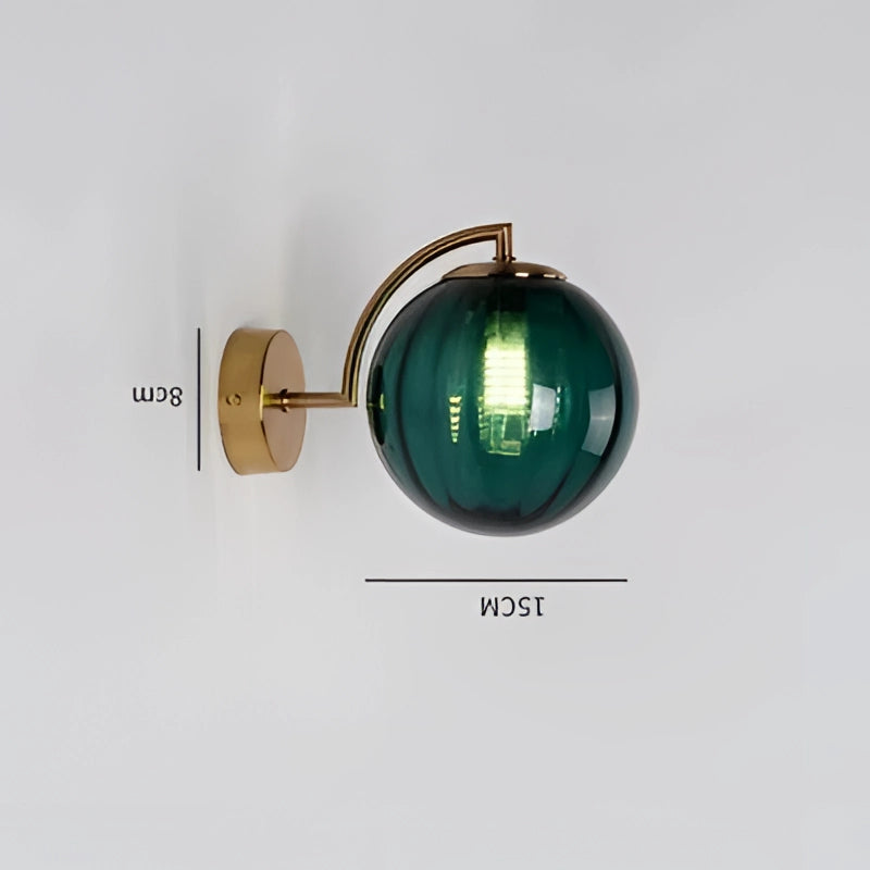 Modern brass globe wall sconce with a green hue, featuring a cylindrical design and metallic finish, measuring 22.7cm in width.