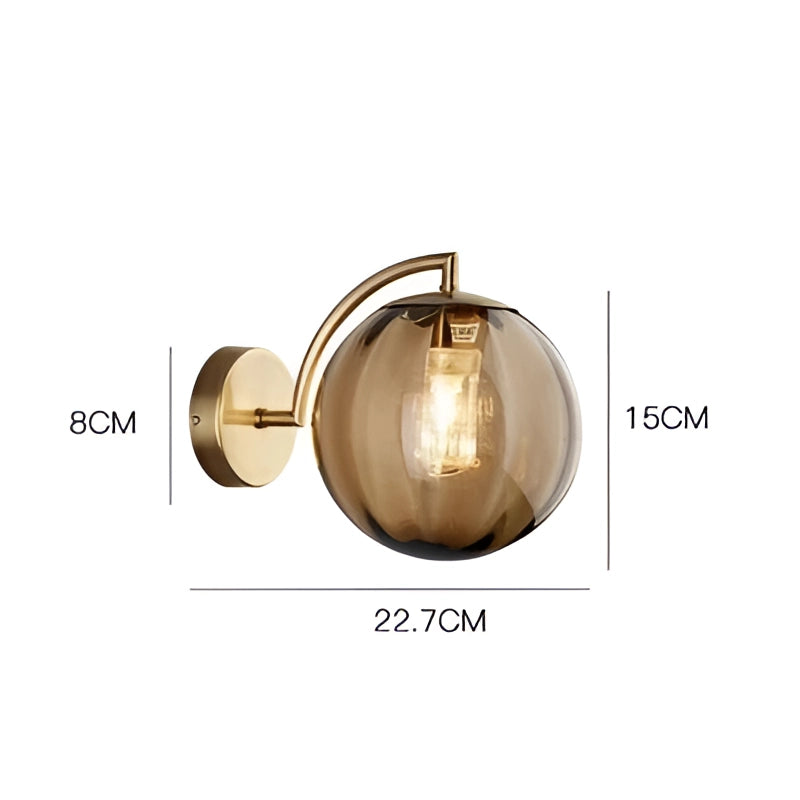 Modern brass globe wall sconce in coffee finish mounted on a wall, featuring a smooth circular design with a diameter of 22.7cm. The brass fixture holds a decorative lamp, adding a touch of elegance and sophistication to the interior space.