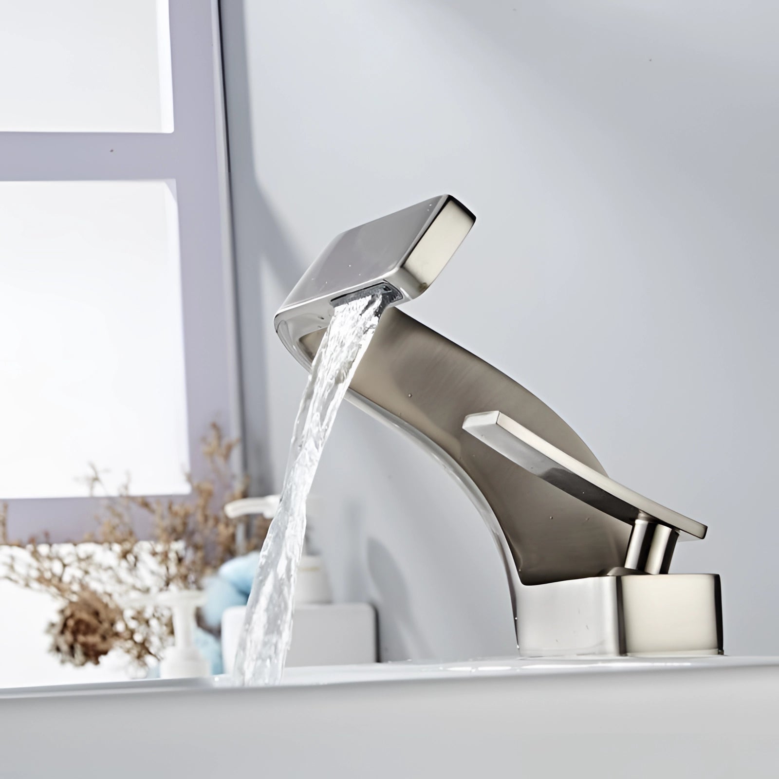 
A brushed nickel modern chrome waterfall faucet with a luxury square spout designed for a basin mixer.