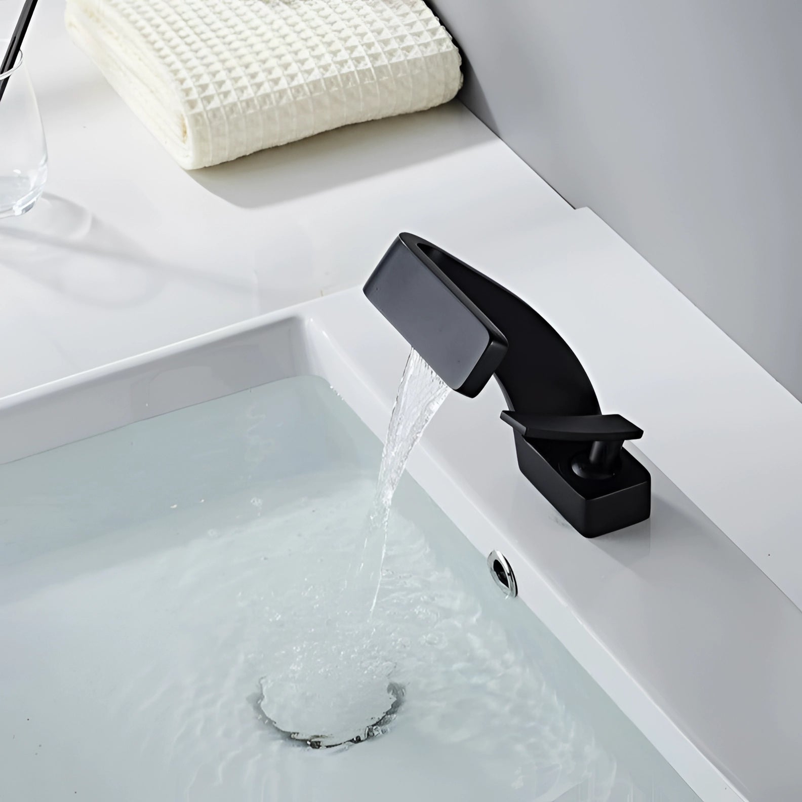 Modern chrome waterfall faucet with a luxury square spout designed for a contemporary basin mixer, showcasing sleek and stylish lines suitable for a modern bathroom decor.