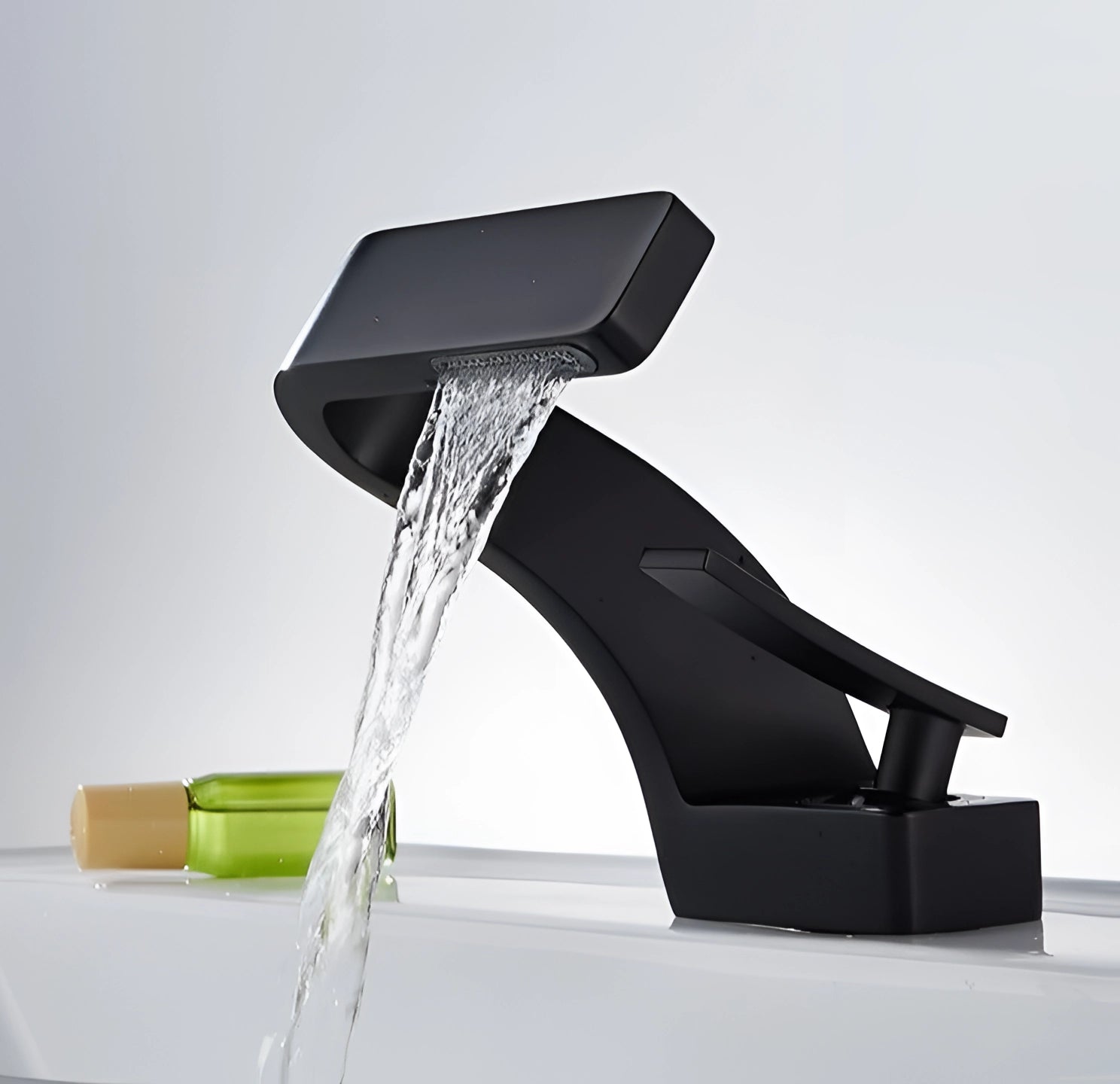 Modern chrome waterfall faucet with a luxury square spout design, installed on a basin. The sleek and contemporary metal finish gives a stylish and sophisticated look, complemented by the rectangular shape of the spout that elegantly pours water, resembling a waterfall effect.