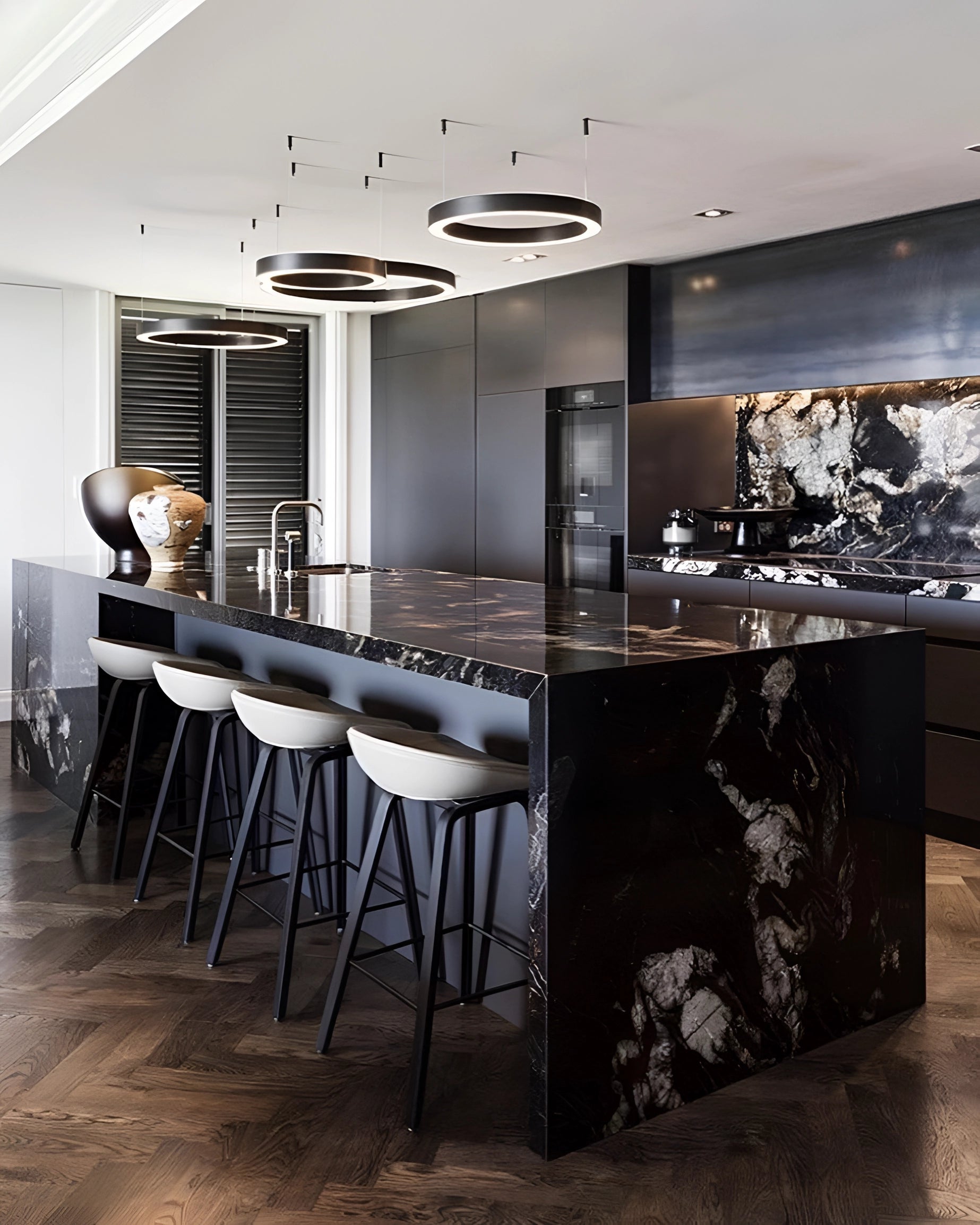 Modern circular LED ring pendant light illuminating a luxurious hotel lobby with elegant interior design, featuring hardwood flooring and a spacious open layout.