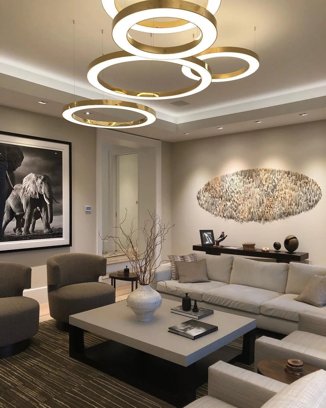 Modern Circular LED Ring Pendant Light illuminating a luxury hotel lobby, featuring sleek and elegant design elements. The warm ambient glow enhances the sophisticated interior design, highlighting the stylish furniture and decor in the space.