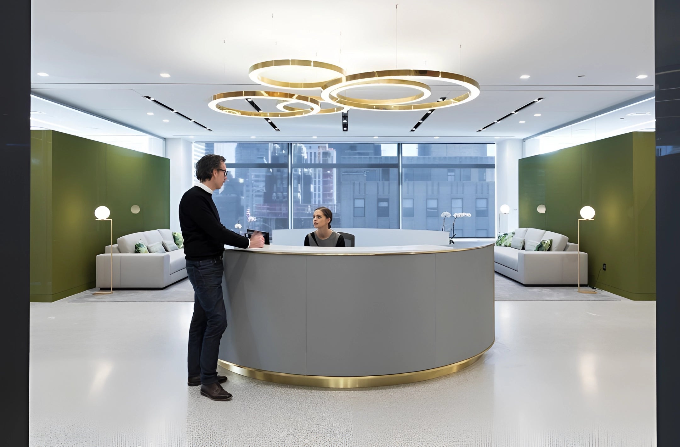 Modern circular LED ring pendant light illuminating a luxury hotel lobby, with sleek design elements like a contemporary table, stylish chairs, and vibrant houseplants, creating an elegant and welcoming atmosphere.