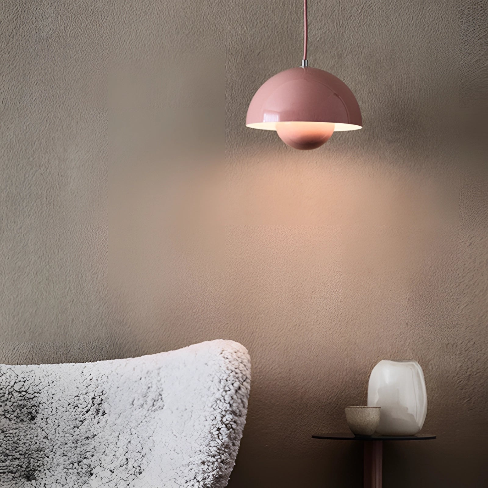 A pink modern copper pendant light with a Scandinavian minimalist design, featuring a smooth wooden shade and subtle linear accents.