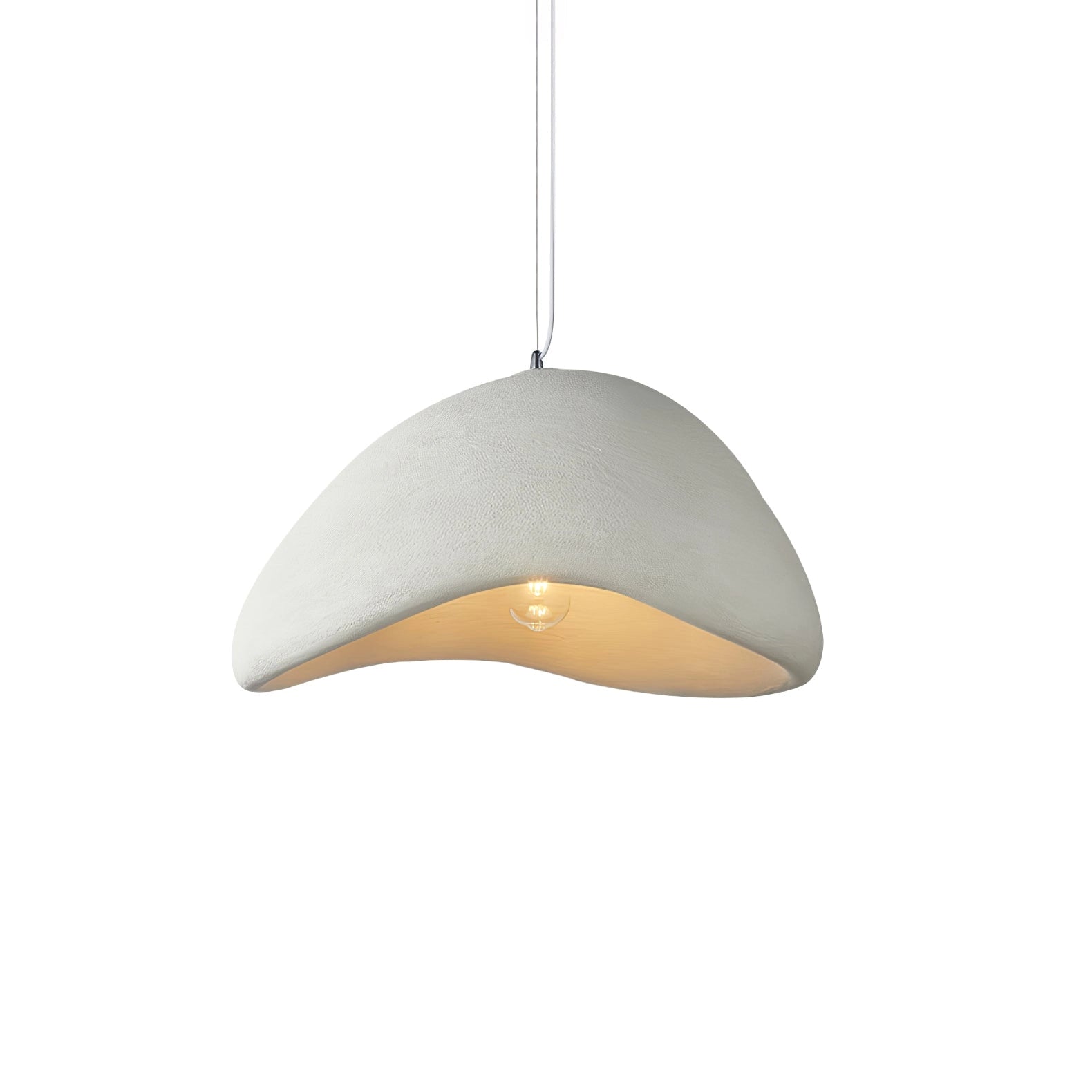 Modern curved pendant light hanging from a ceiling, showcasing its minimalist sculptural design with a mix of wood and metal elements, casting subtle shadows on the table below.