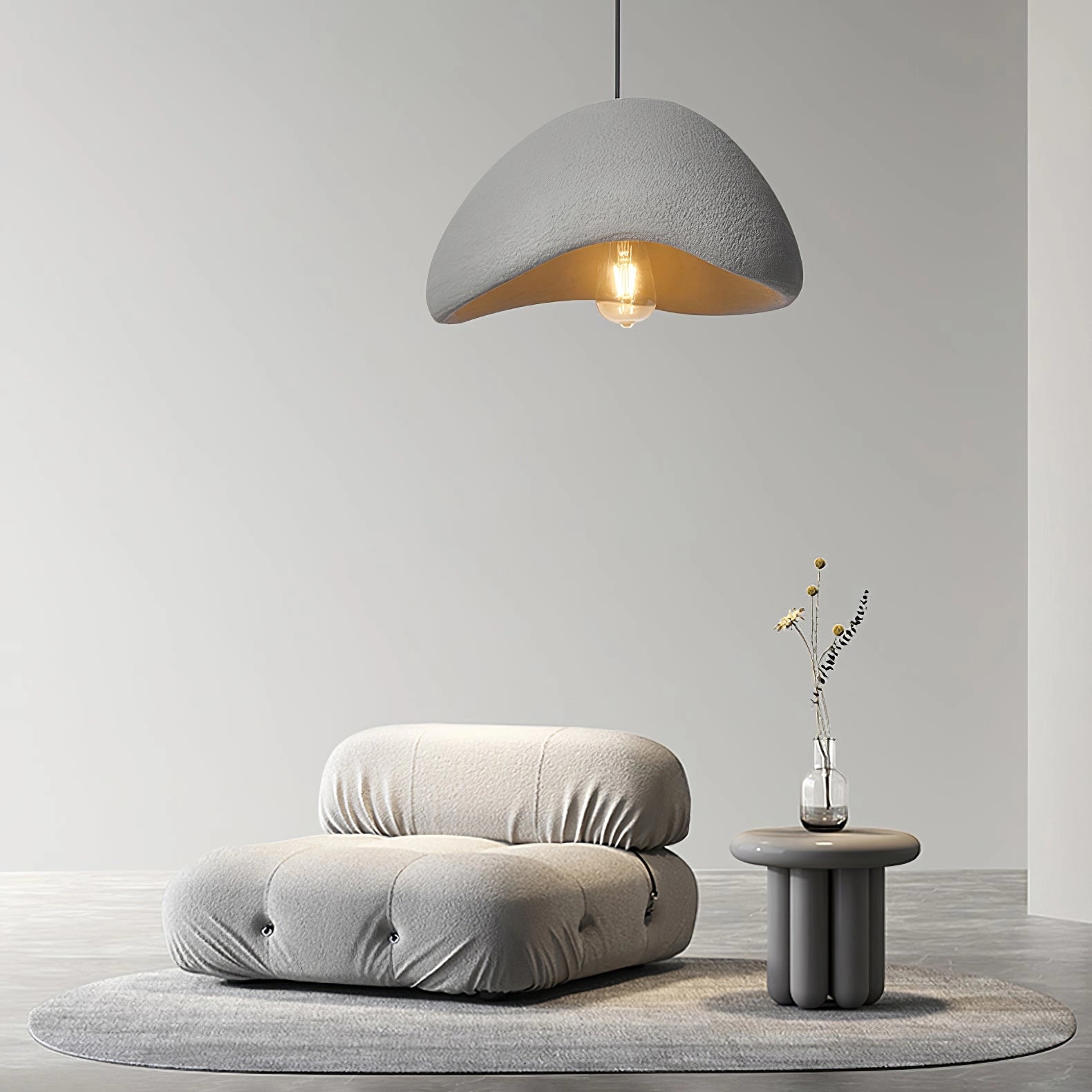 Modern curved pendant light in a minimalist sculptural design, featuring a gray finish with dimensions of 30cm in diameter and 20cm in height, suspended in an interior setting with elements of wood and contemporary decor.