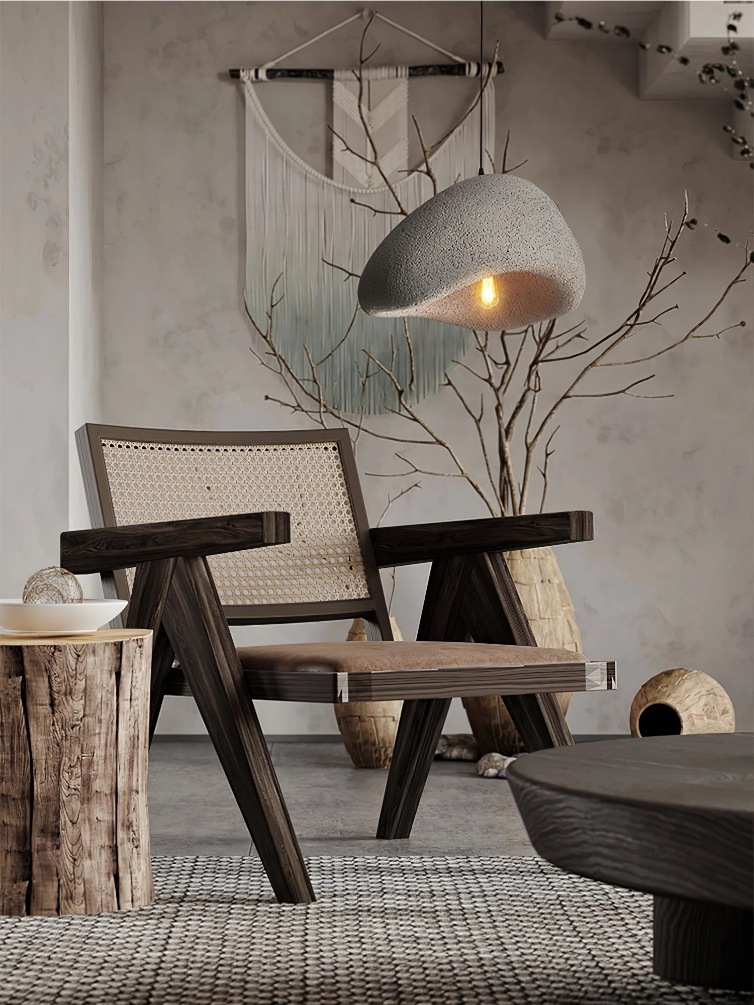 Modern curved pendant light with a minimalist sculptural design, featuring a wooden branch-like structure hanging in an interior setting with grey tones.