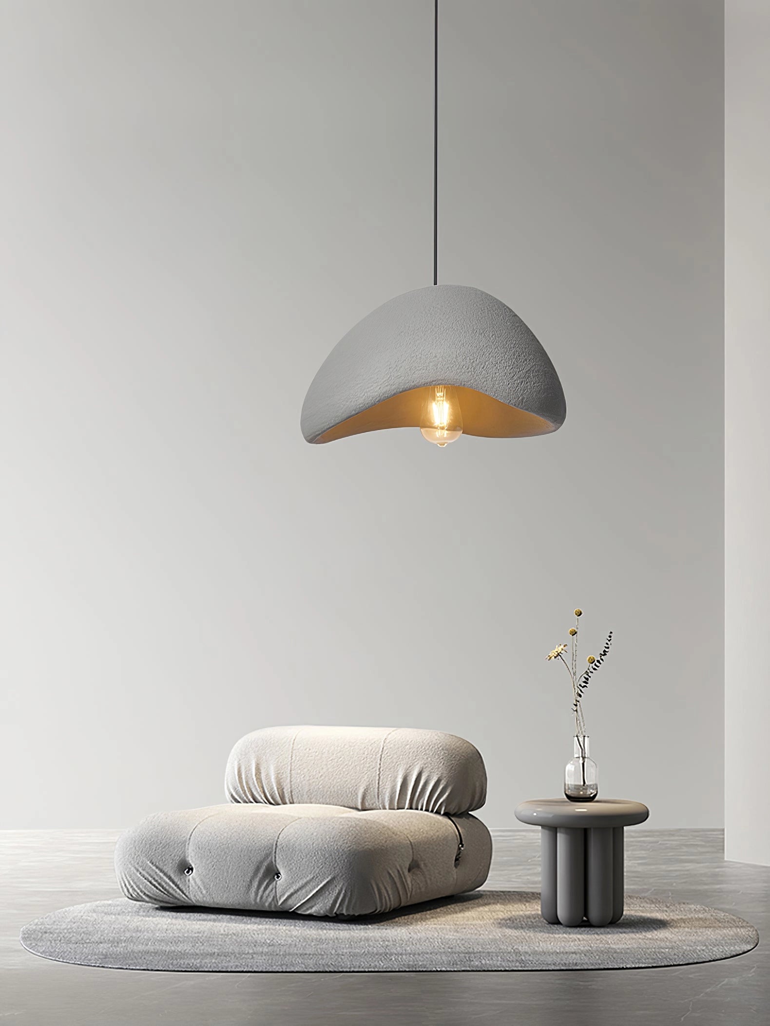 Modern curved pendant light with a minimalist sculptural design, featuring a gray shade and wooden accents. The lamp hangs from the ceiling, illuminating the space with soft, comfortable lighting. Measures 40cm in diameter and 25cm in height.