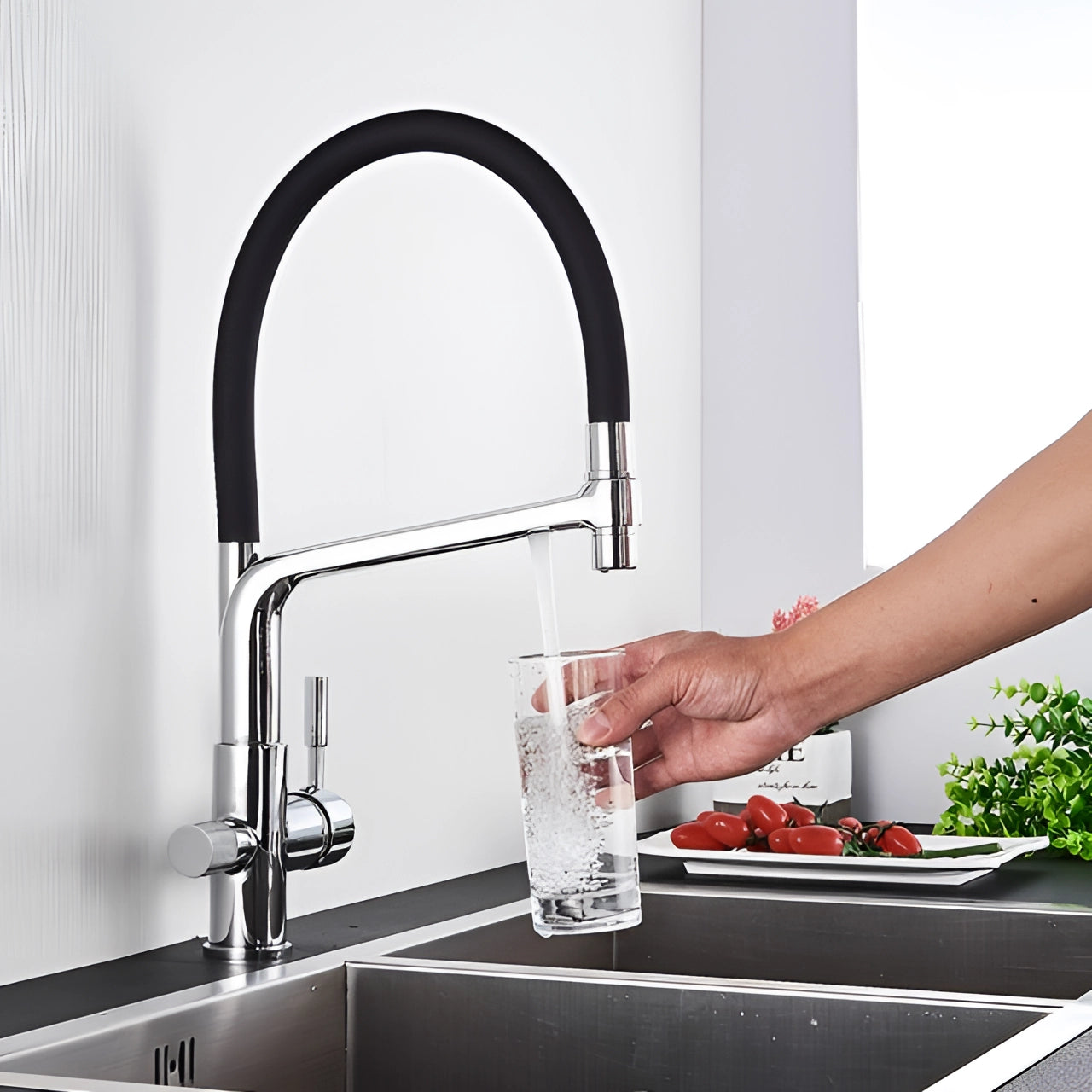 Modern silver dual-function black and chrome pull-down kitchen faucet installed over a countertop sink, featuring sleek automotive-inspired design and efficient plumbing functionality.