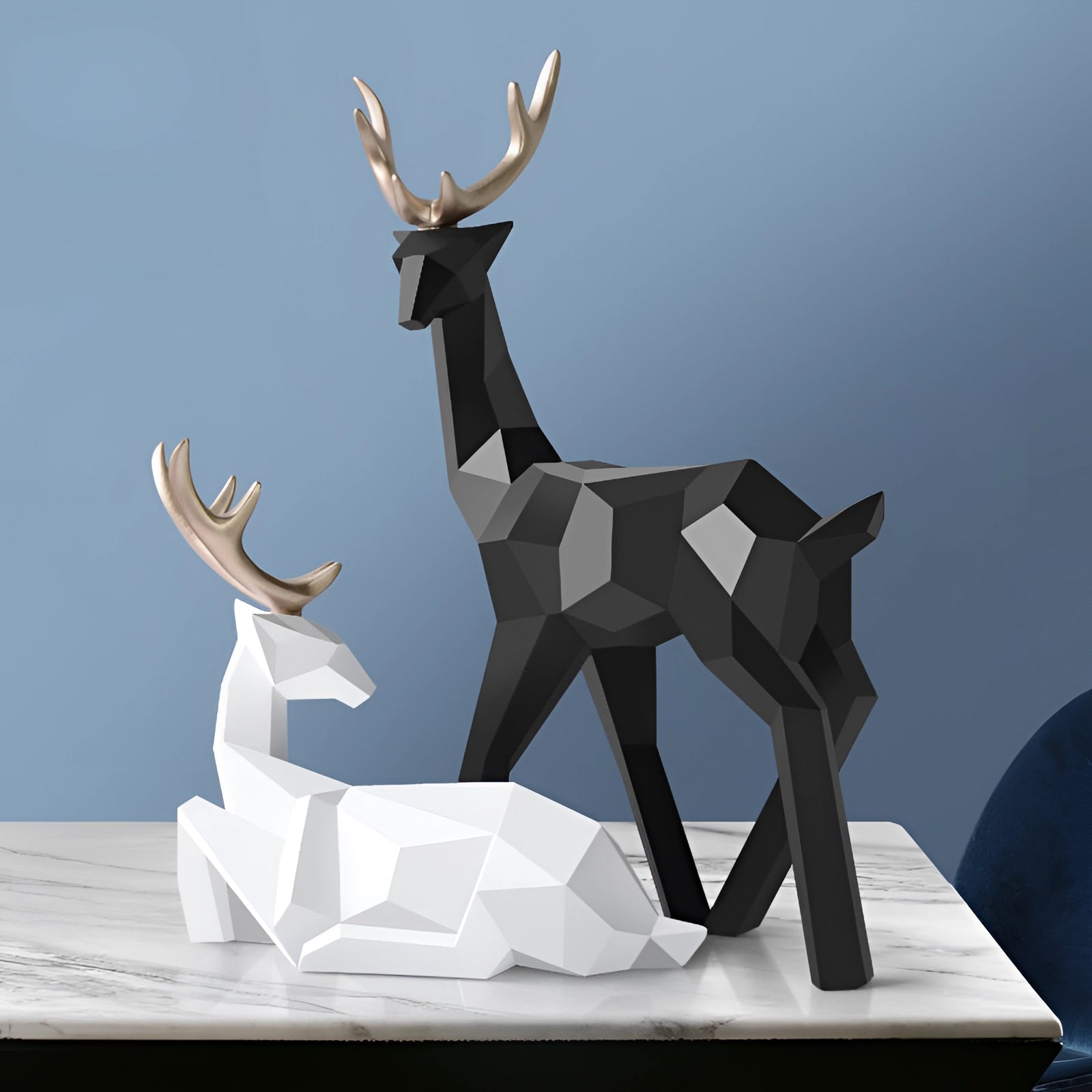 Black and white minimalist geometric sculpture of a deer with prominent antlers, designed as modern decor.