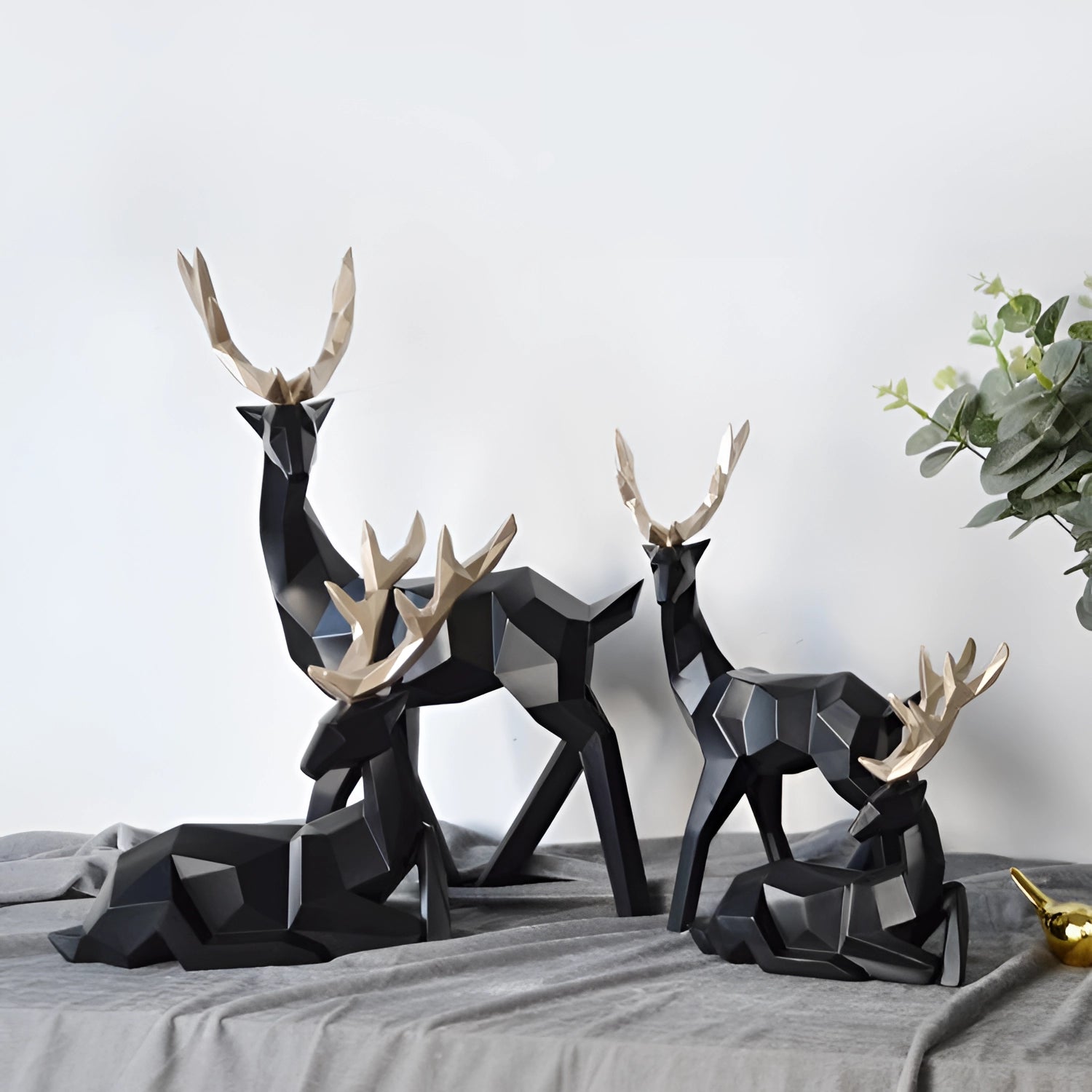 Modern geometric deer sculpture featuring black and white minimalist design, crafted with a combination of natural materials like wood and metal, showcasing detailed antlers and wildlife-inspired artistry.